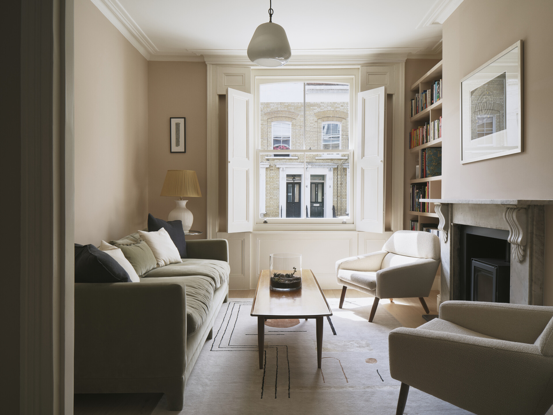 Located toward the front of the house, this original living room, with a built-in bookshelf, retains its character but has been updated with subtle, modern interventions. Victorian details like cornices and fireplaces are preserved, while the palette and finishes bring it in line with the rest of the home’s design.