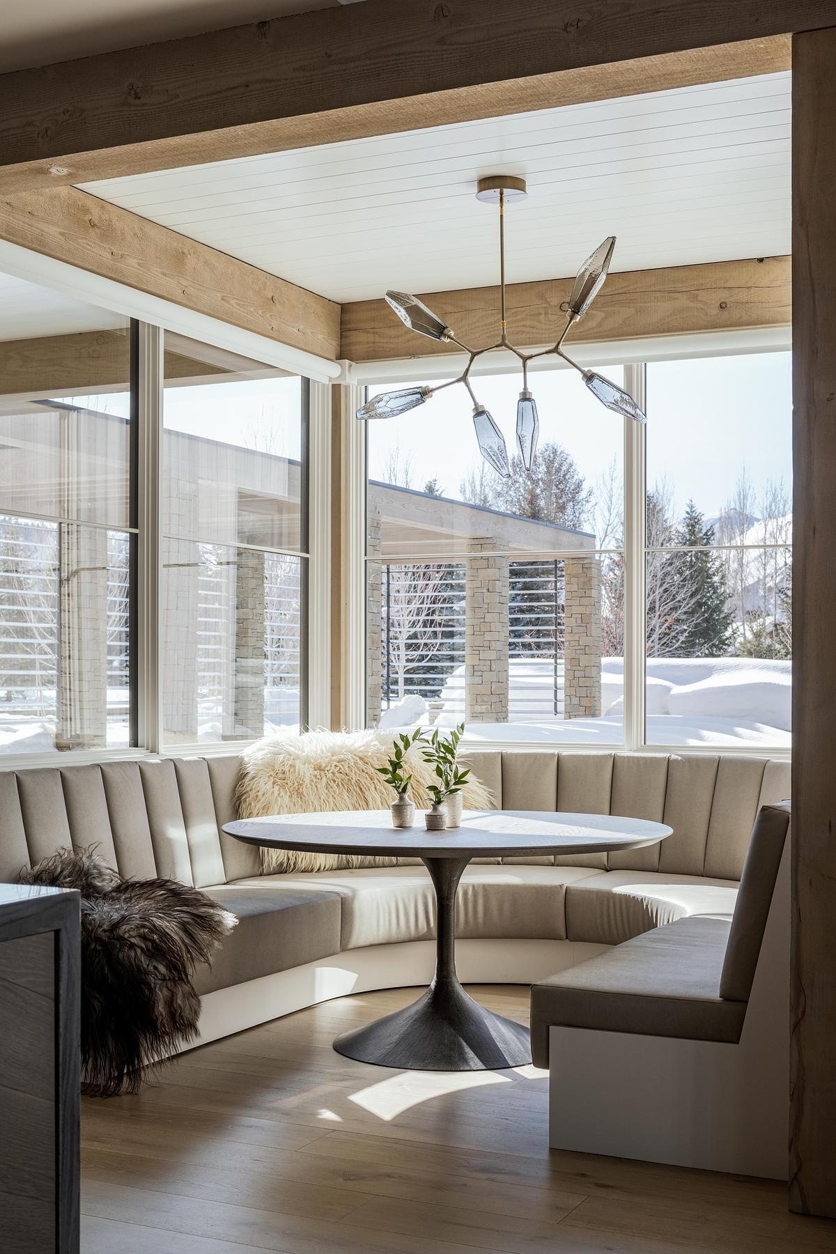 A custom dining banquette framed by garden views offers a relaxed, built-in space to gather, equal parts elegant and everyday.