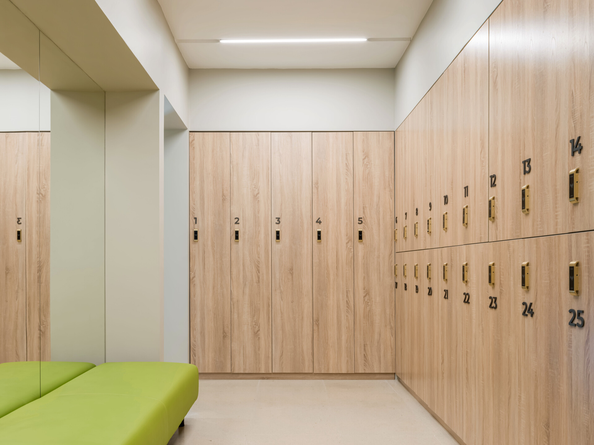 The second floor of SIAM SPA takes on a more minimalist mood with smooth grey walls, veined wood accents, and lush greenery. Custom wooden fitness equipment blends beauty with function, offering a serene environment for stretching, strength, and movement.