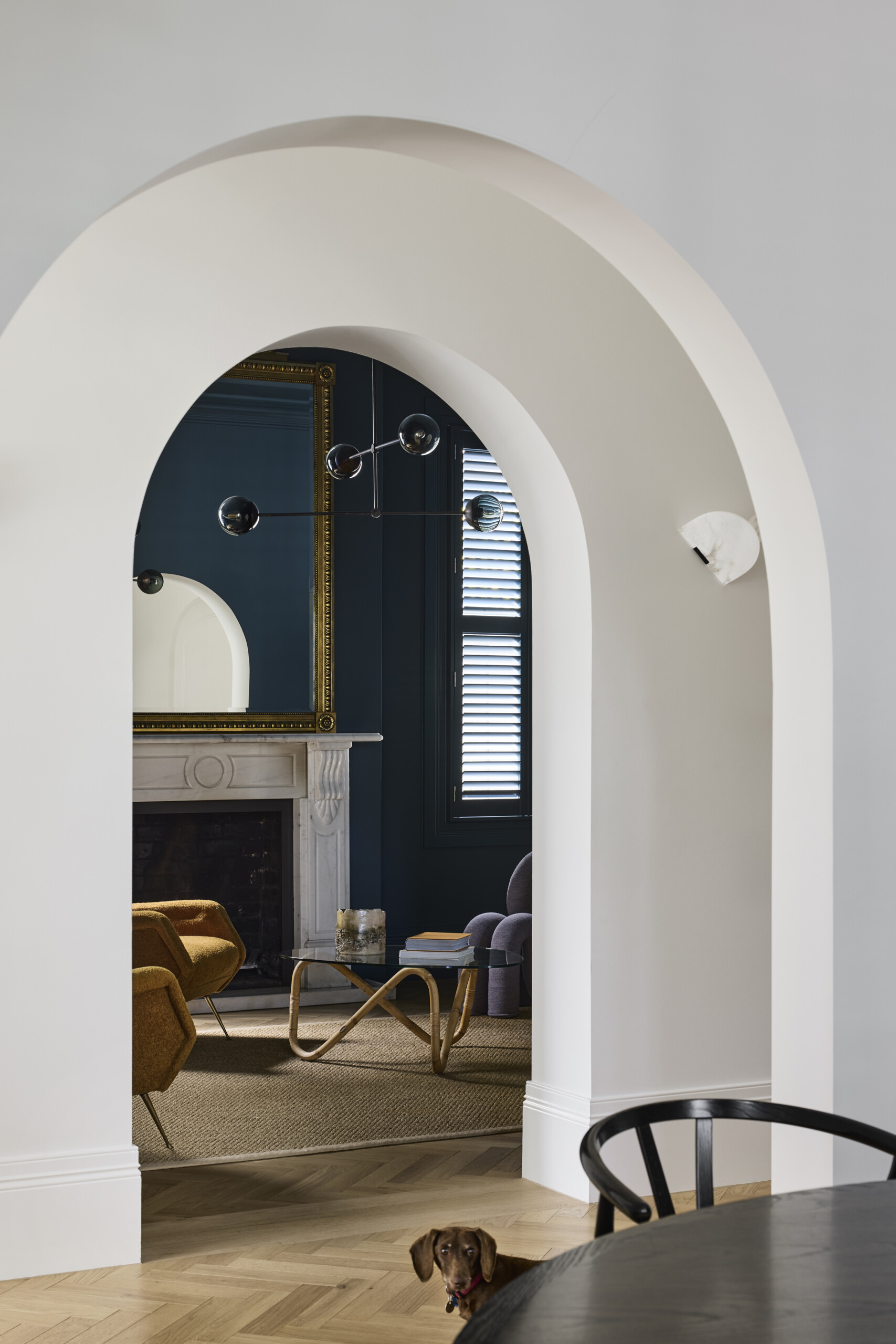 Arched details pair the heritage bones of the house with more contemporary gestures. They serve as thresholds between old and new, softening transitions and adding sculptural interest for the dining room and sitting room.