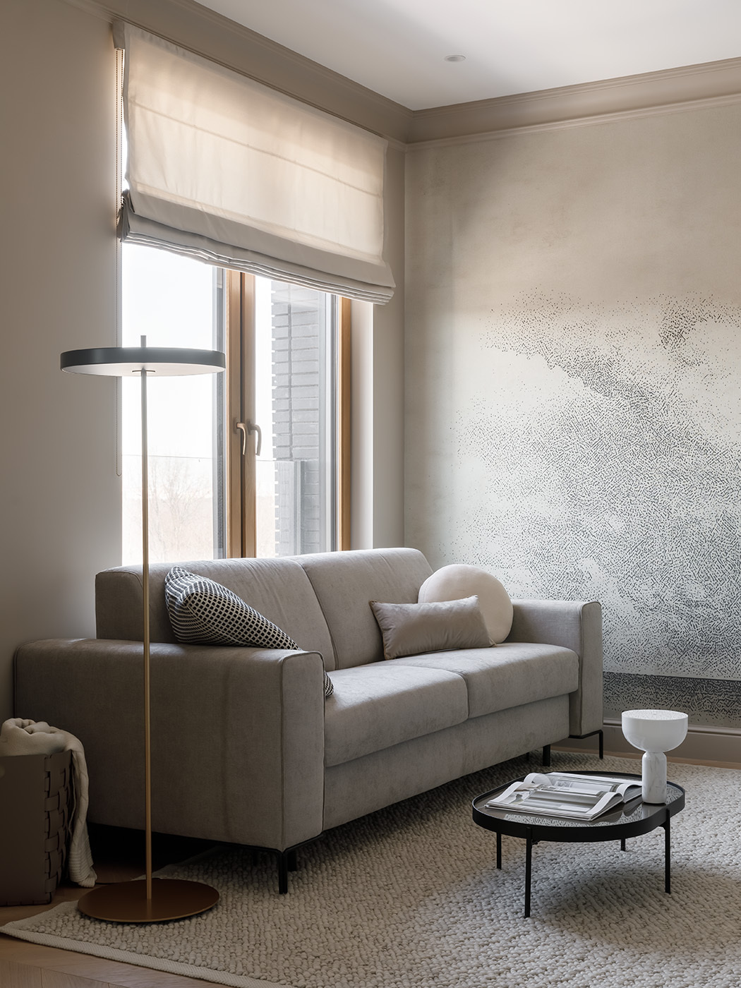 In the living room, a bold stork mural sets the tone, a symbol of happiness and family. A sculpted wood coffee table echoes the bird’s natural habitat, while soft light, a Felis sofa, and Danish accents complete the calm, layered look.