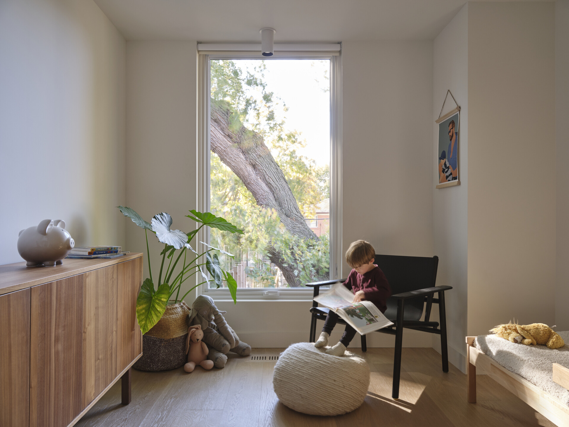 In this kids bedroom, storage furniture and built-in closets keep the room tidy, while strategically placed windows offer framed views of the backyard or sky.