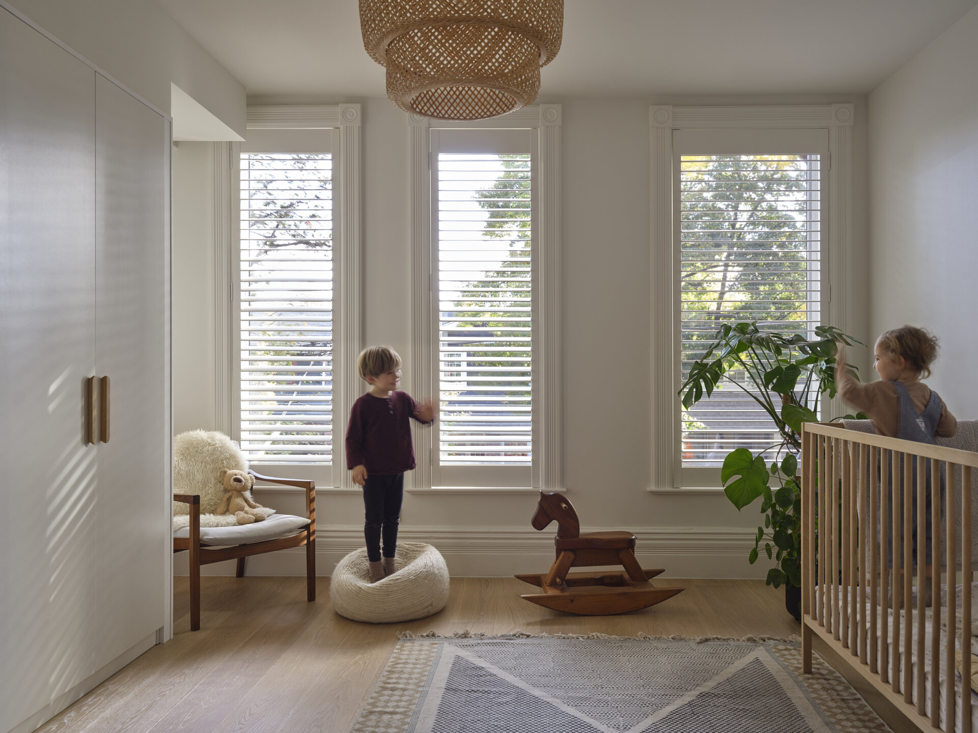 In this kids bedroom, storage furniture and built-in closets keep the room tidy, while strategically placed windows offer framed views of the backyard or sky.