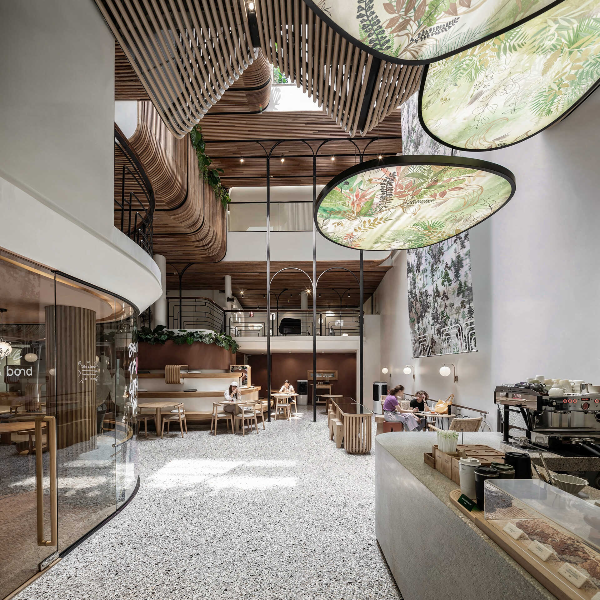 At the heart of the hostel, a light-filled internal courtyard with curved wooden facades and planted balconies offers a serene oasis amid the city’s tight urban fabric. There's also a cafe and tiered seating.