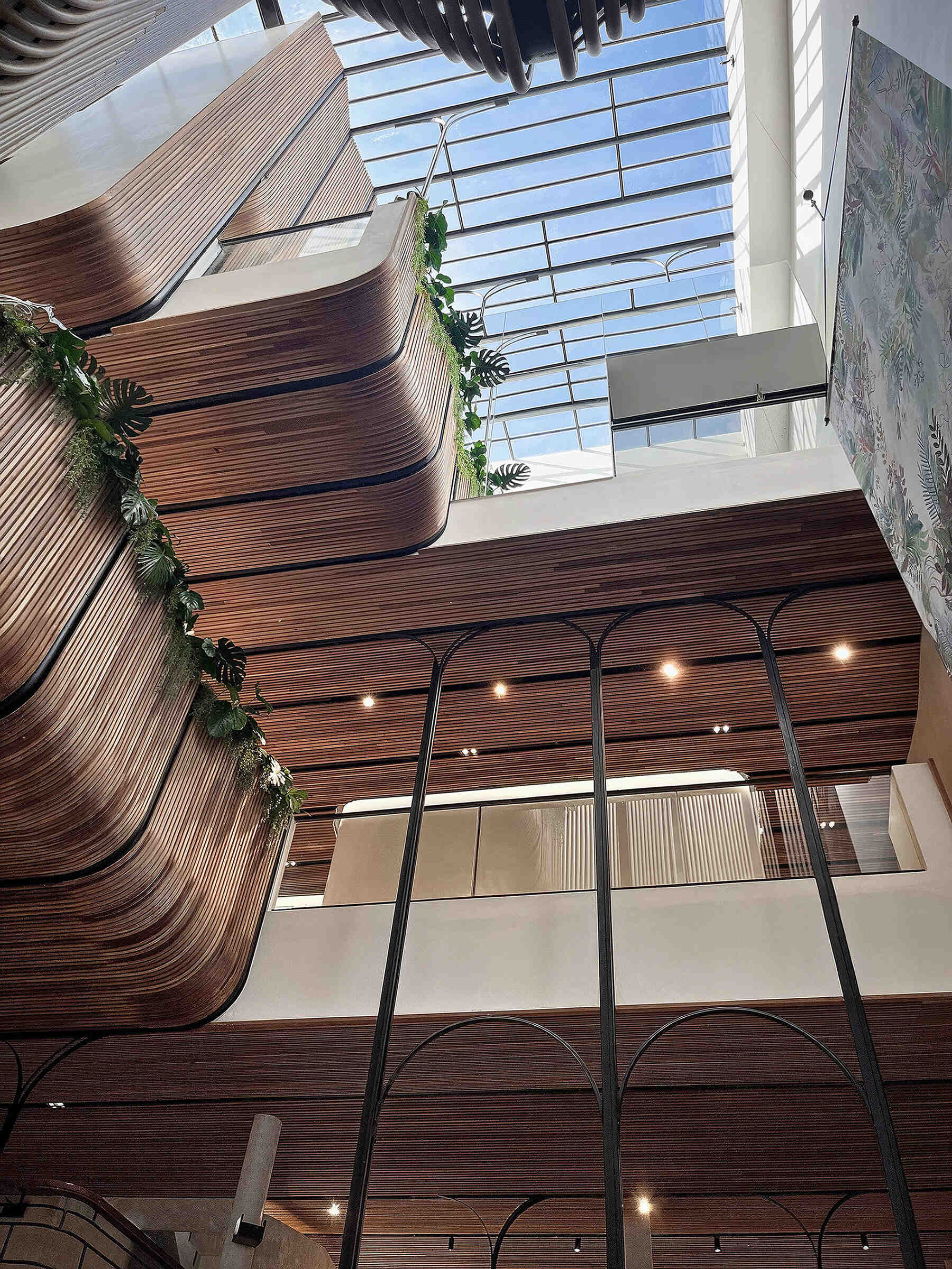 At the heart of the hostel, a light-filled internal courtyard with curved wooden facades and planted balconies offers a serene oasis amid the city’s tight urban fabric. There's also a cafe and tiered seating.