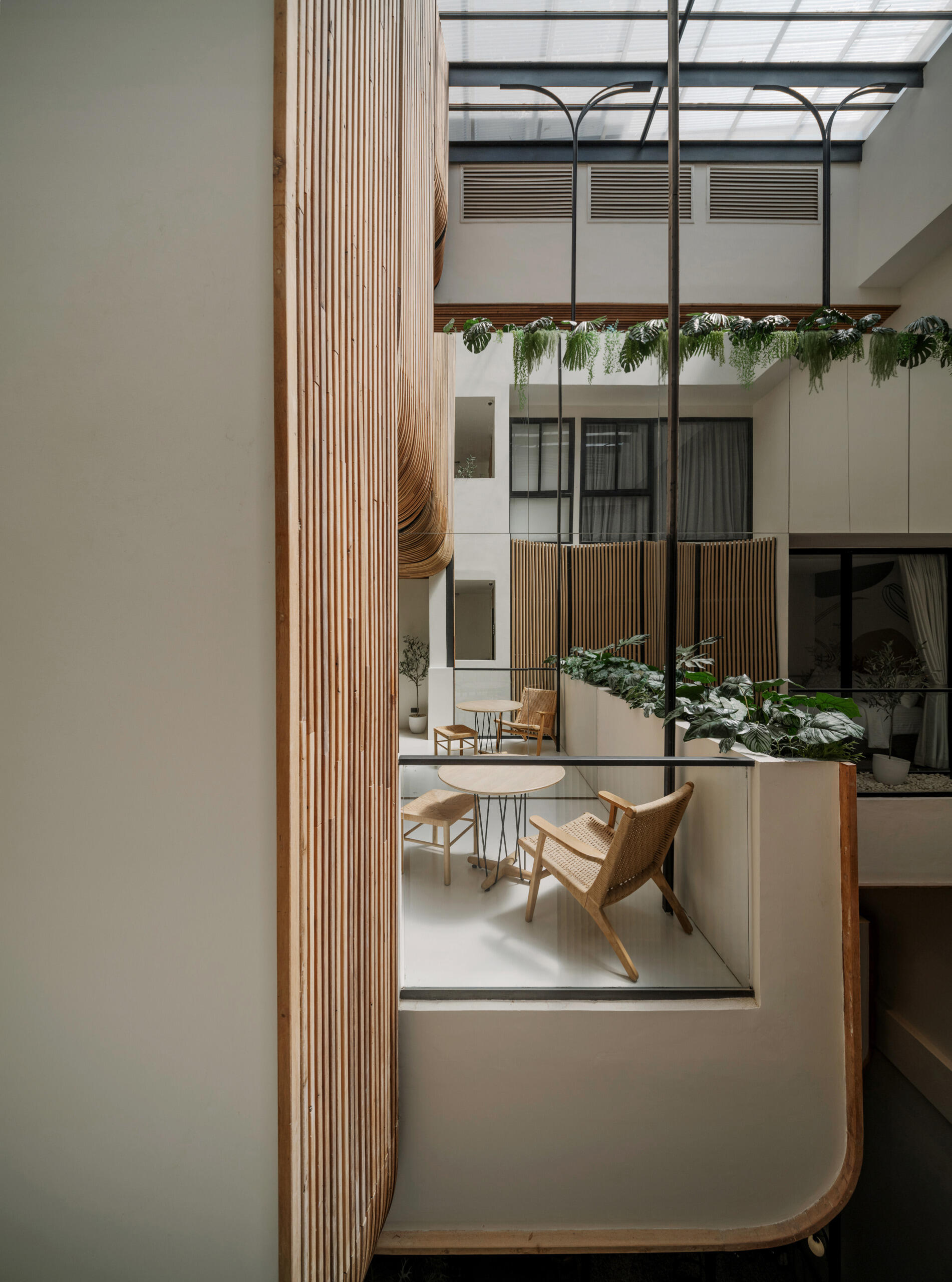 At the heart of the hostel, a light-filled internal courtyard with curved wooden facades and planted balconies offers a serene oasis amid the city’s tight urban fabric. There's also a cafe and tiered seating.