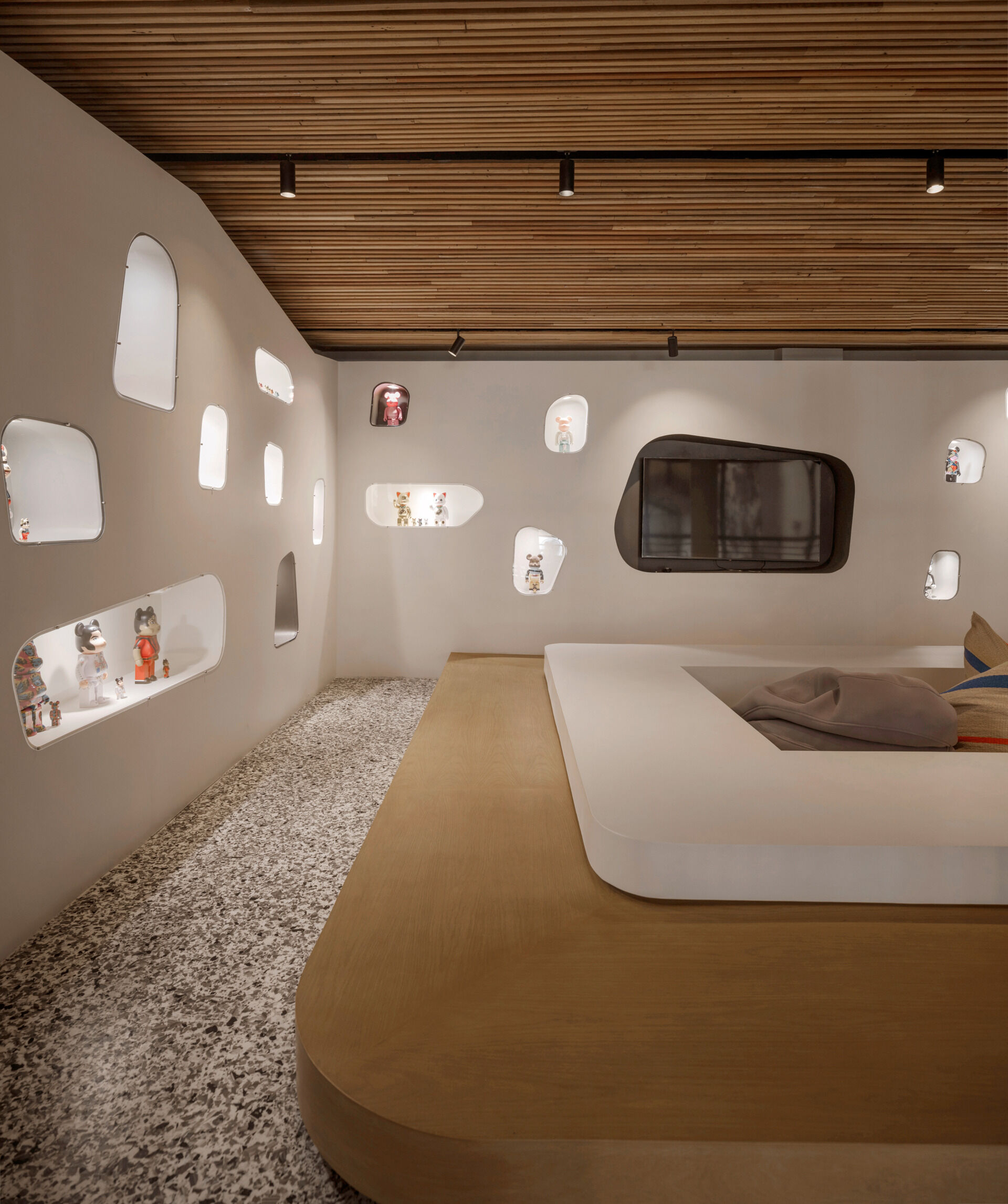 The hallways of this hostel carry through the warm, tactile quality established in the courtyard. Corridors are lined with reclaimed timber ceilings and soft lighting, creating a quiet, cocoon-like transition between public and private spaces.