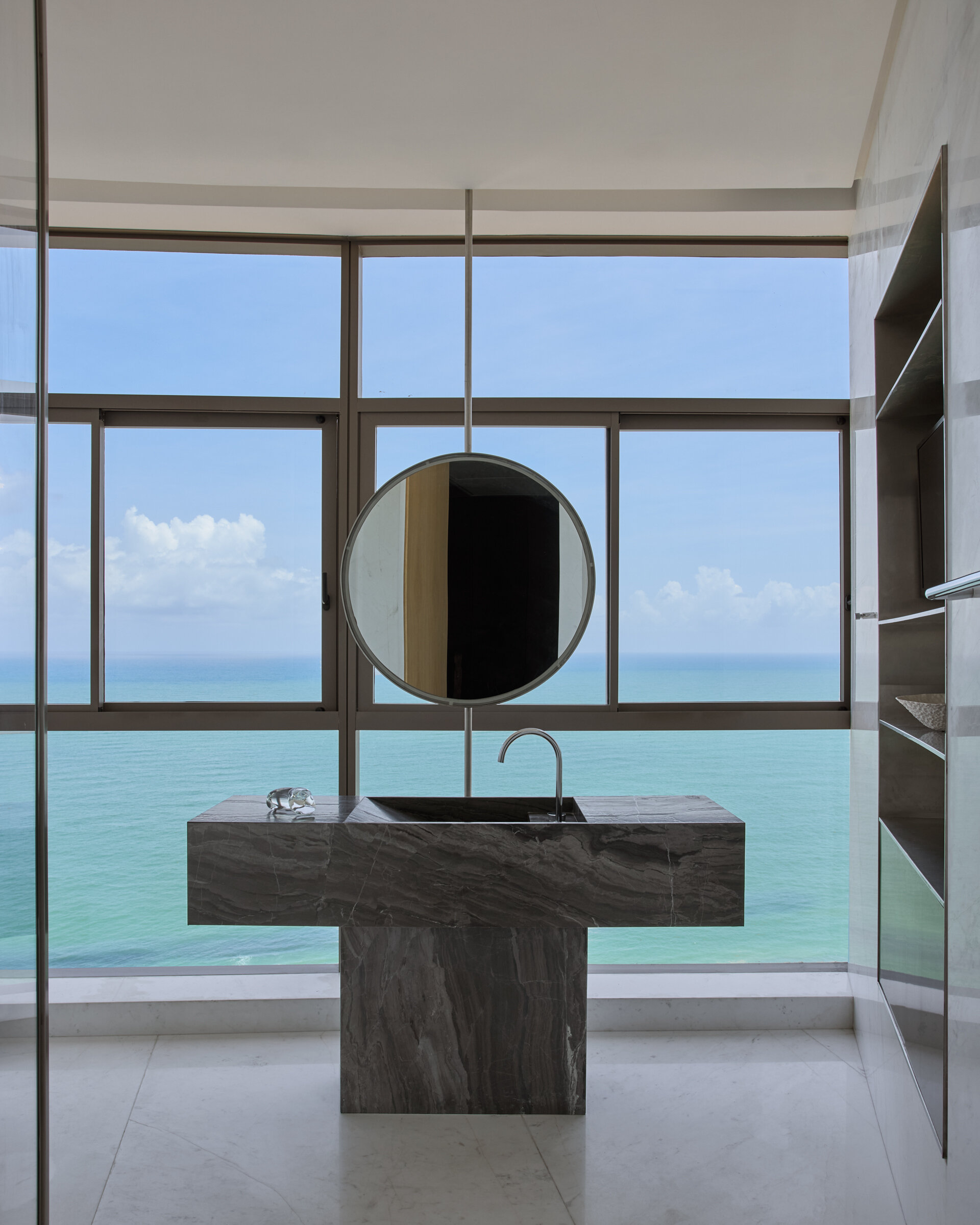 In this modern bathroom, a marble vanity turns a functional element into a sculptural one.