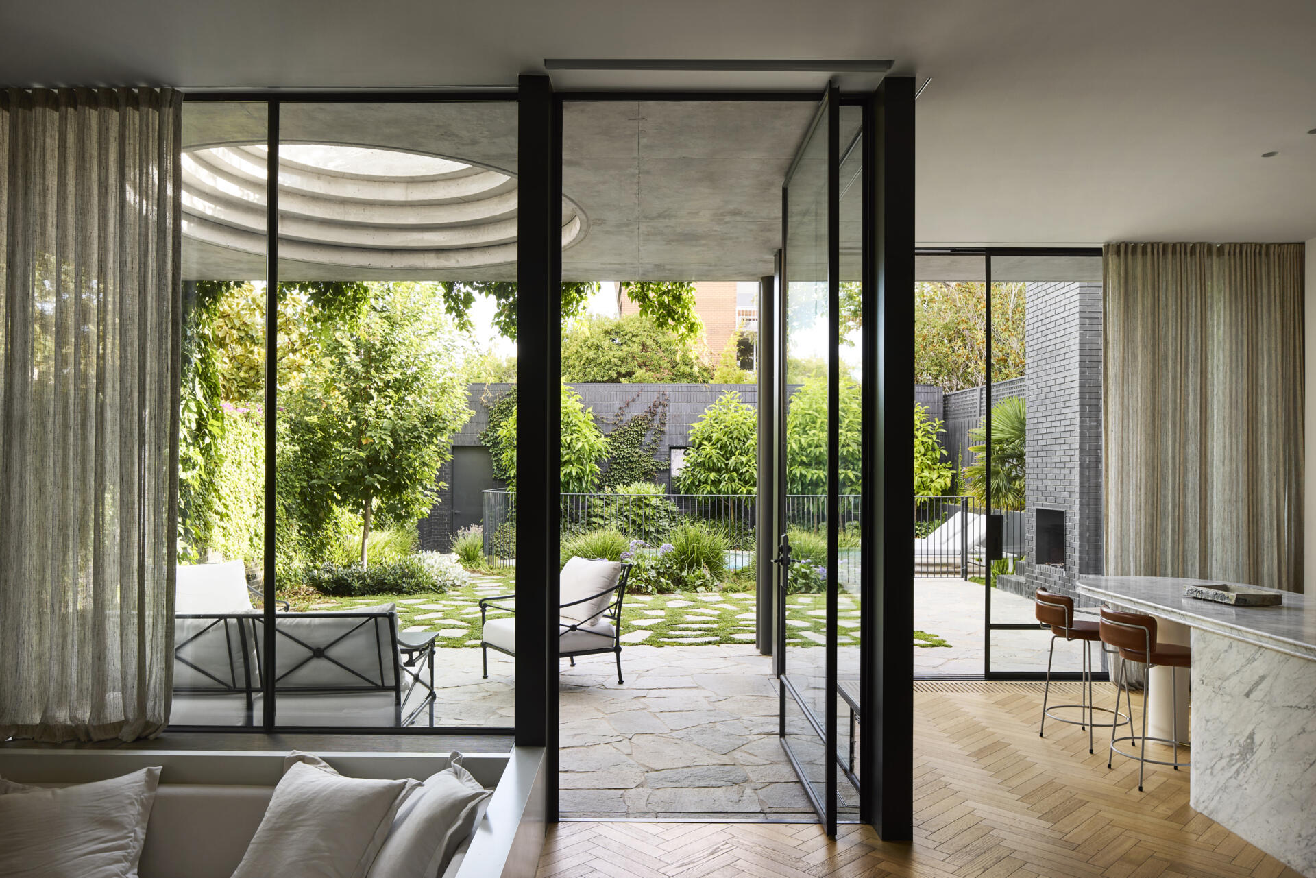 The new kitchen is anchored by a communal island bench, a space for gathering, homework, meals, and conversation. It’s the heart of the home in both function and feel, linking directly to the courtyard and making the most of natural light and garden views.