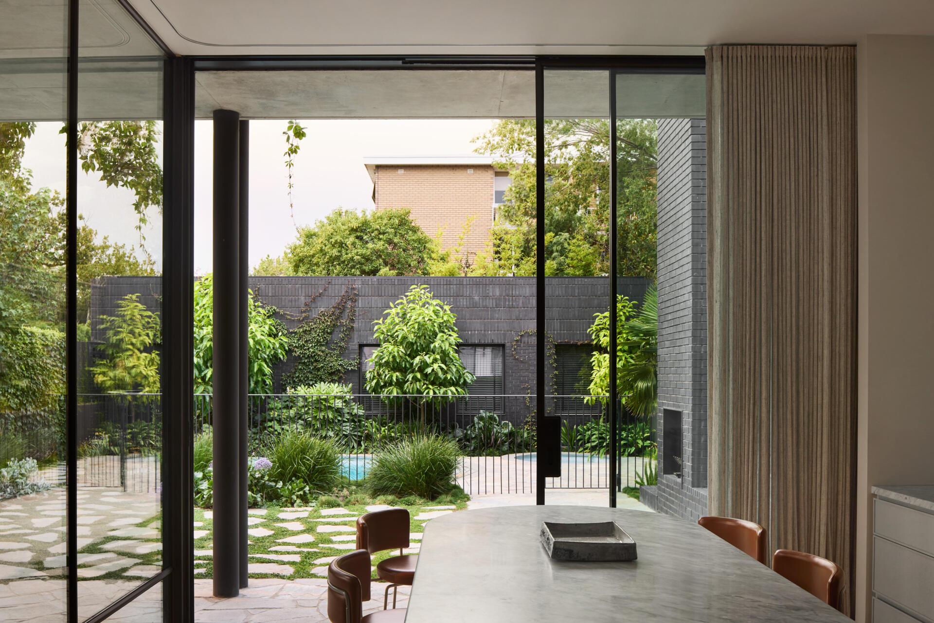 The new kitchen is anchored by a communal island bench, a space for gathering, homework, meals, and conversation. It’s the heart of the home in both function and feel, linking directly to the courtyard and making the most of natural light and garden views.