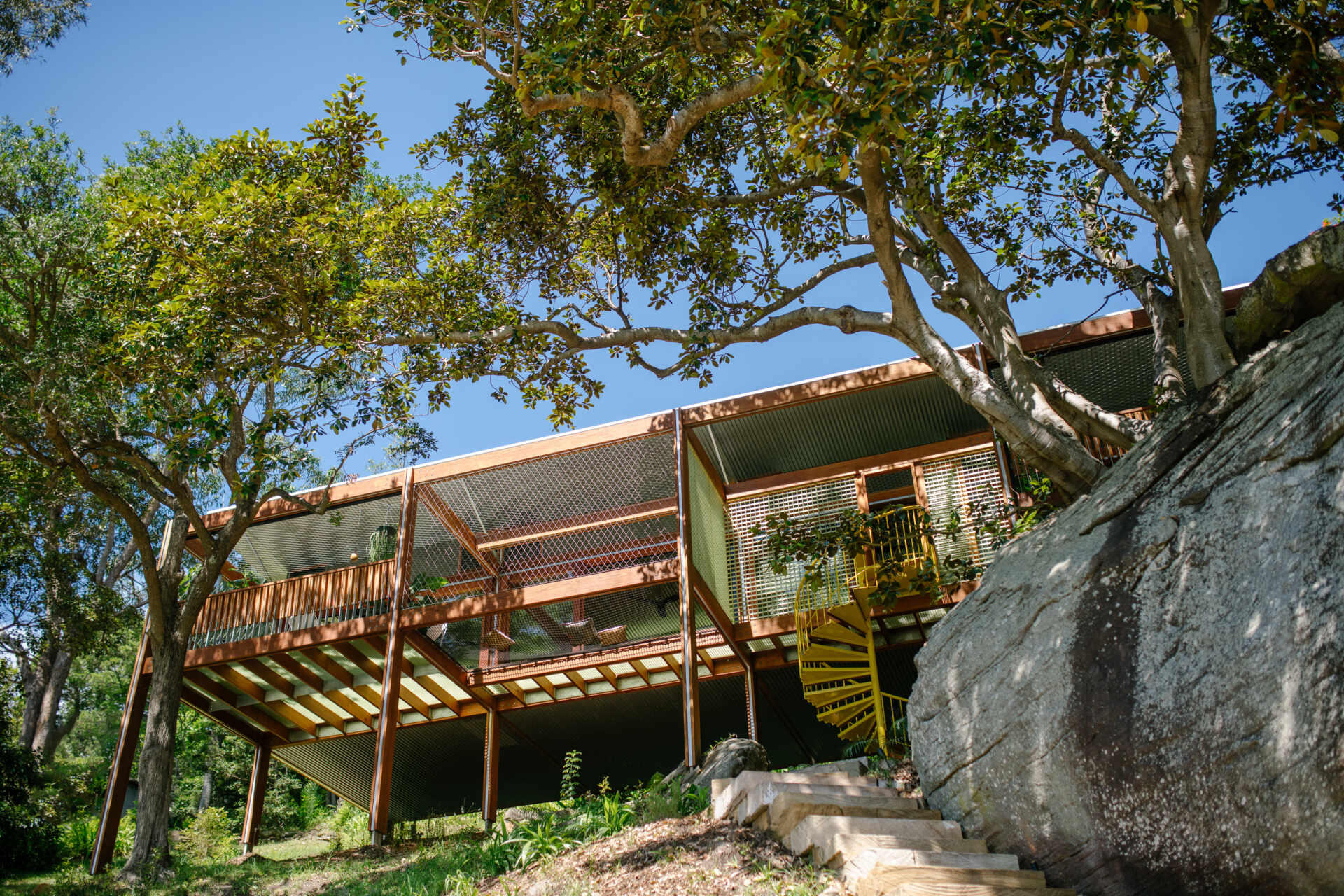 A timber-framed bushland retreat that feels both grounded and elevated, this modest home was assembled like a Meccano set to sit gently among the trees.