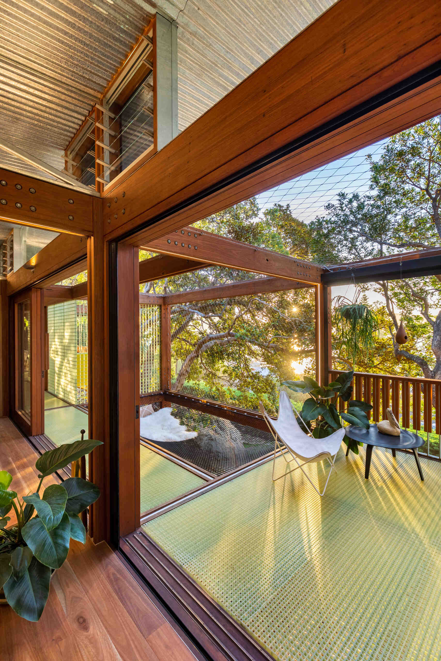 A cargo net hammock bay lets you lie back and float among the leaves, suspended in the treetops of this tranquil Palm Beach escape.