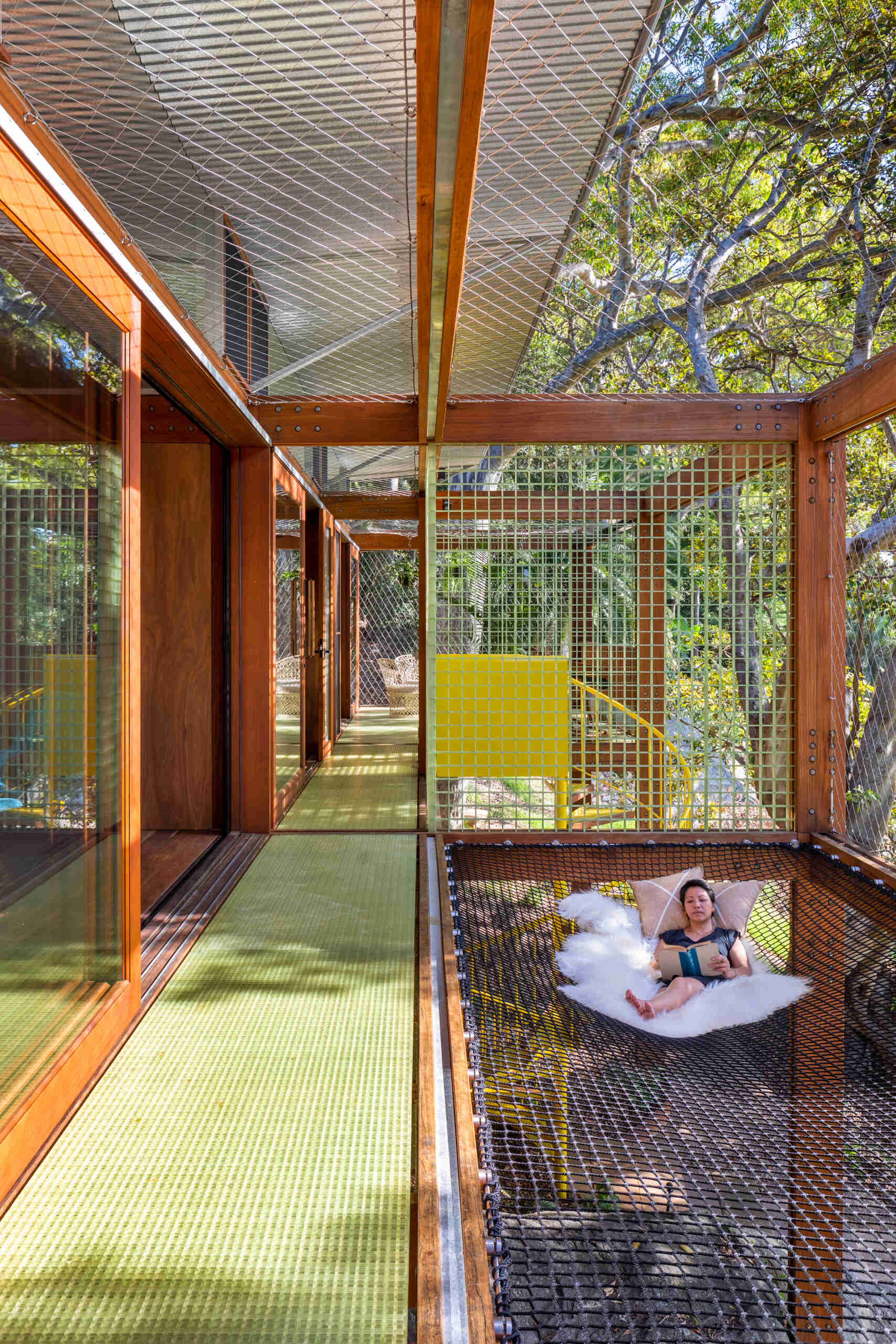 A cargo net hammock bay lets you lie back and float among the leaves, suspended in the treetops of this tranquil Palm Beach escape.