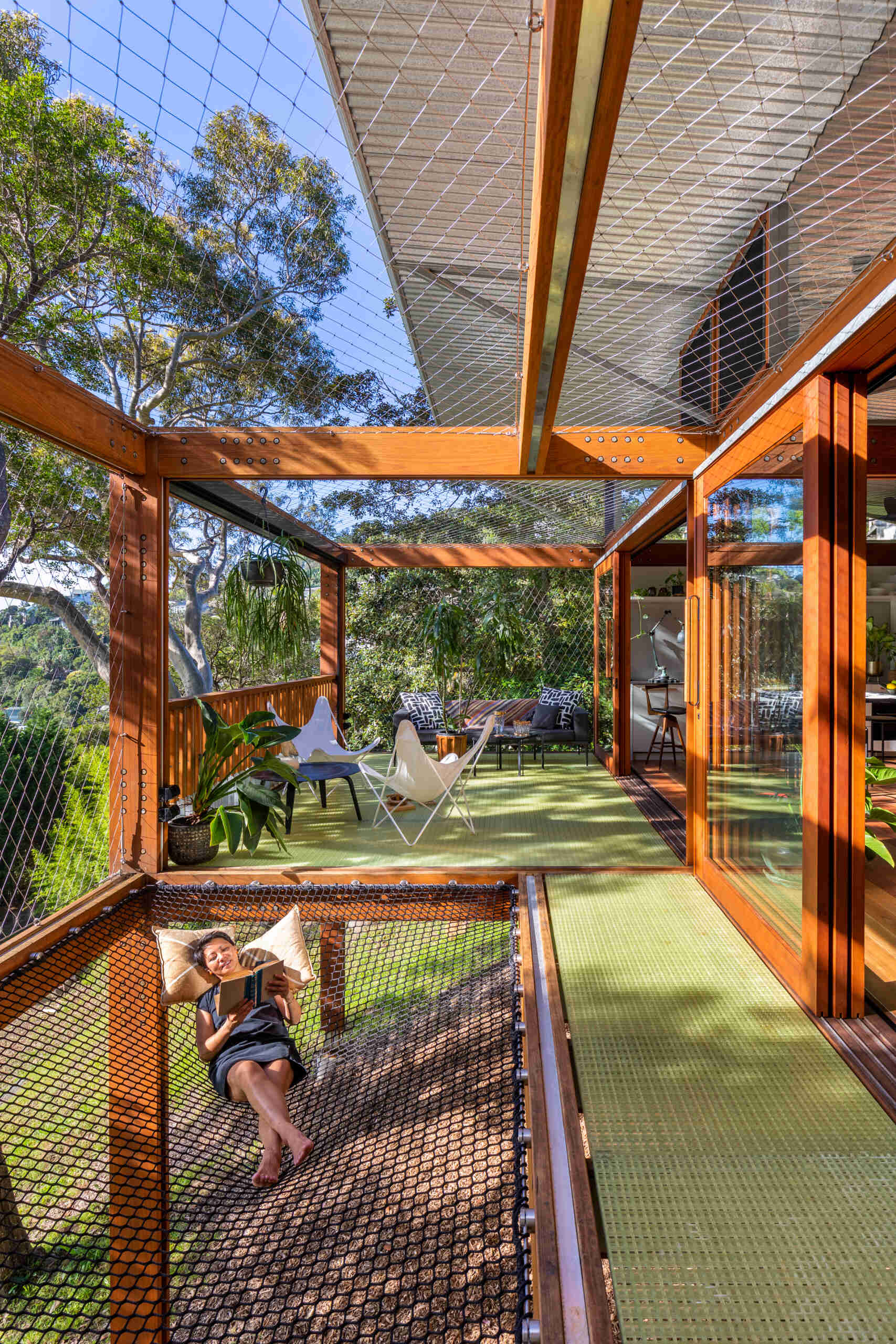 A cargo net hammock bay lets you lie back and float among the leaves, suspended in the treetops of this tranquil Palm Beach escape.