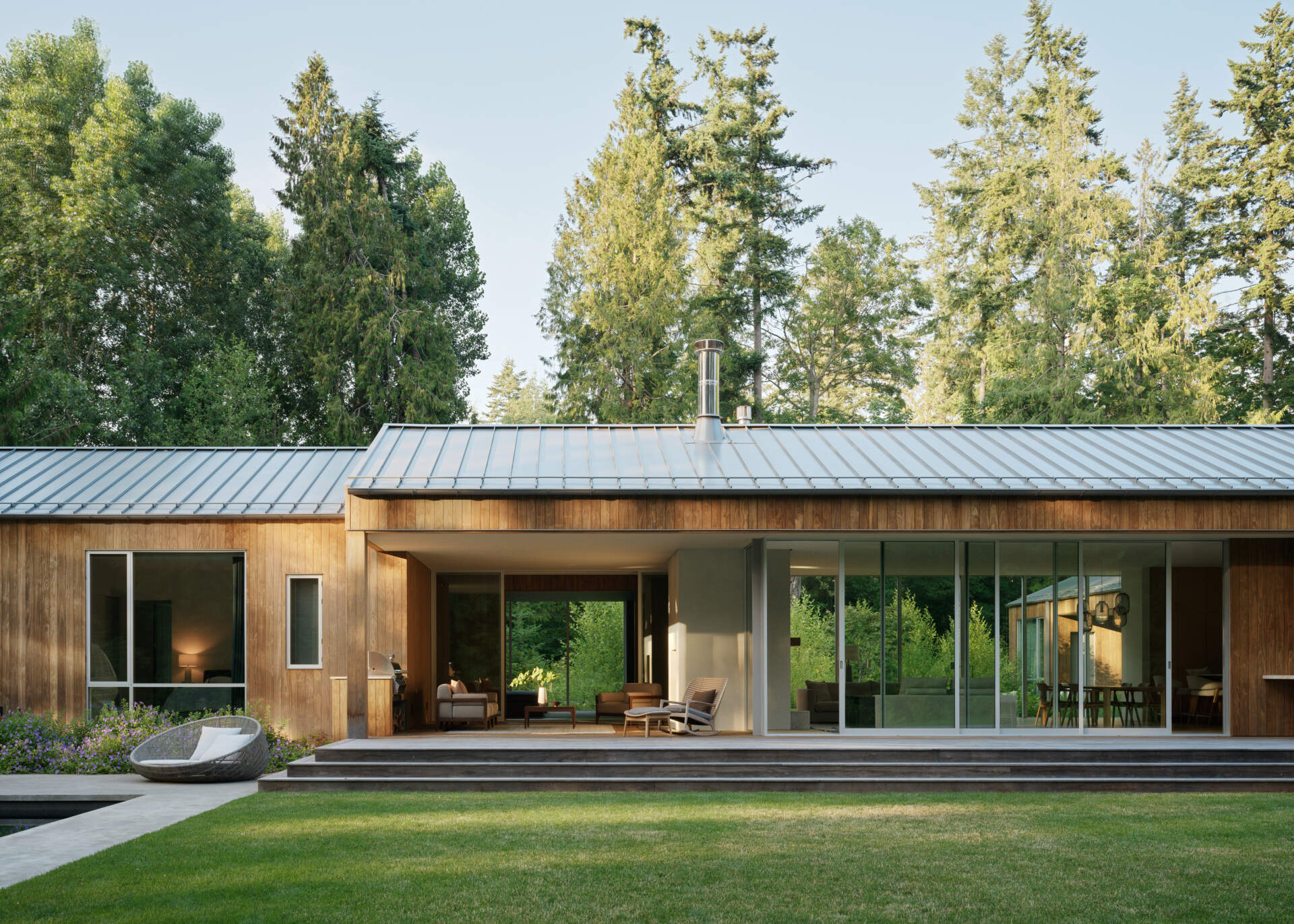 Near the main living areas of this house is a covered outdoor living room that blurs the line between interior and exterior, offering a shaded retreat that functions as a true extension of the house.