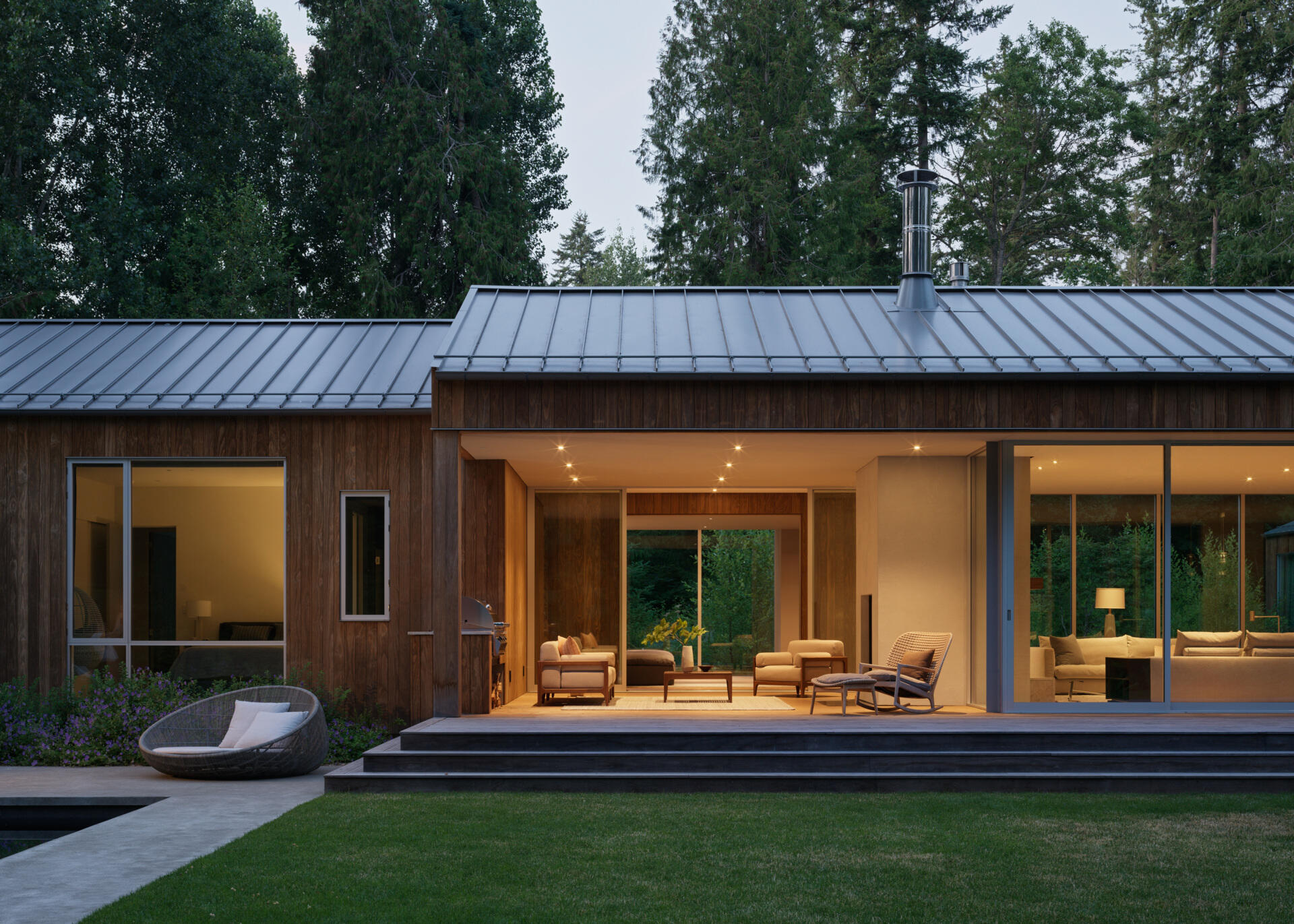 Near the main living areas of this house is a covered outdoor living room that blurs the line between interior and exterior, offering a shaded retreat that functions as a true extension of the house.