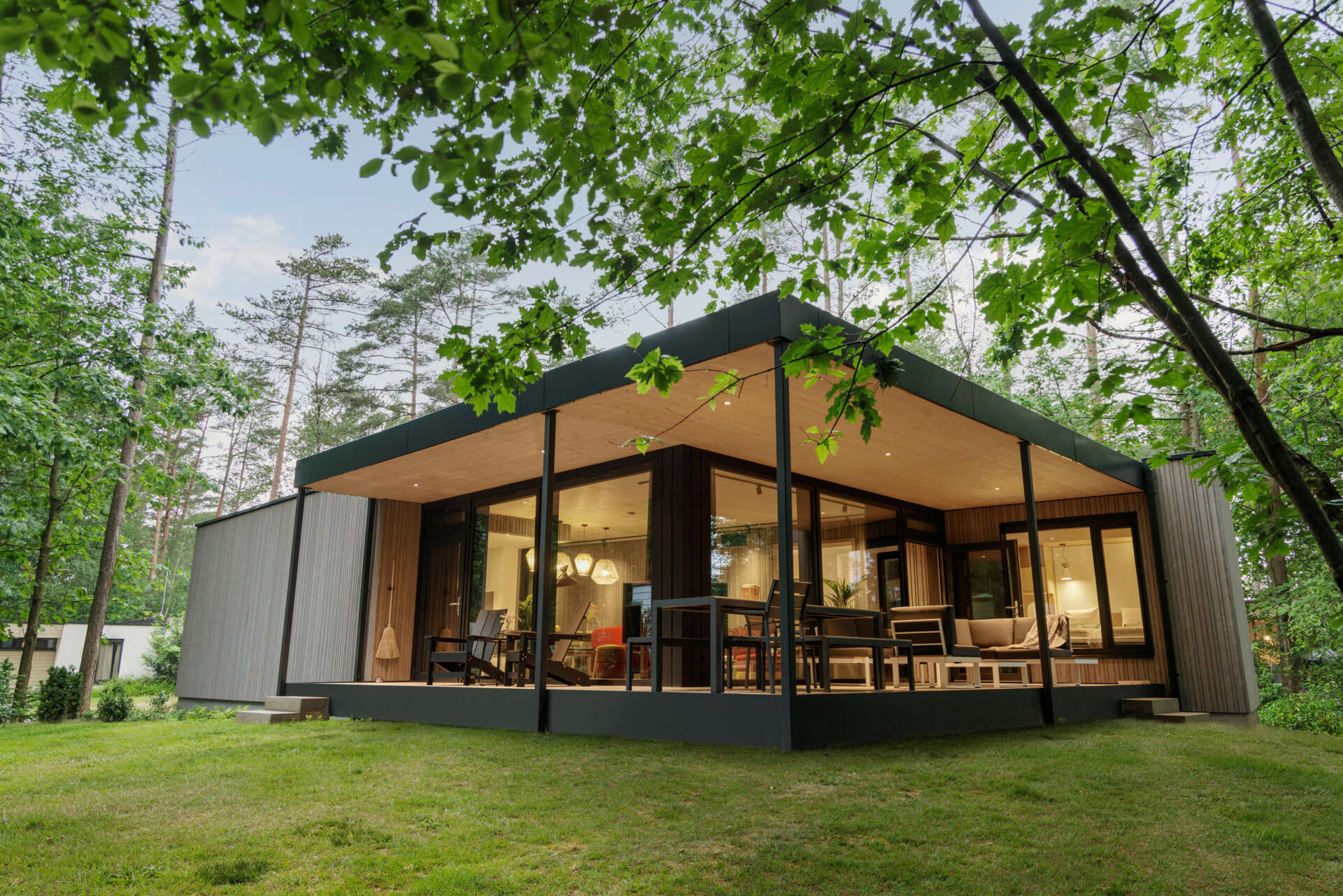 Step inside a modern prefab cottage where minimalist design and natural materials create a serene forest escape.