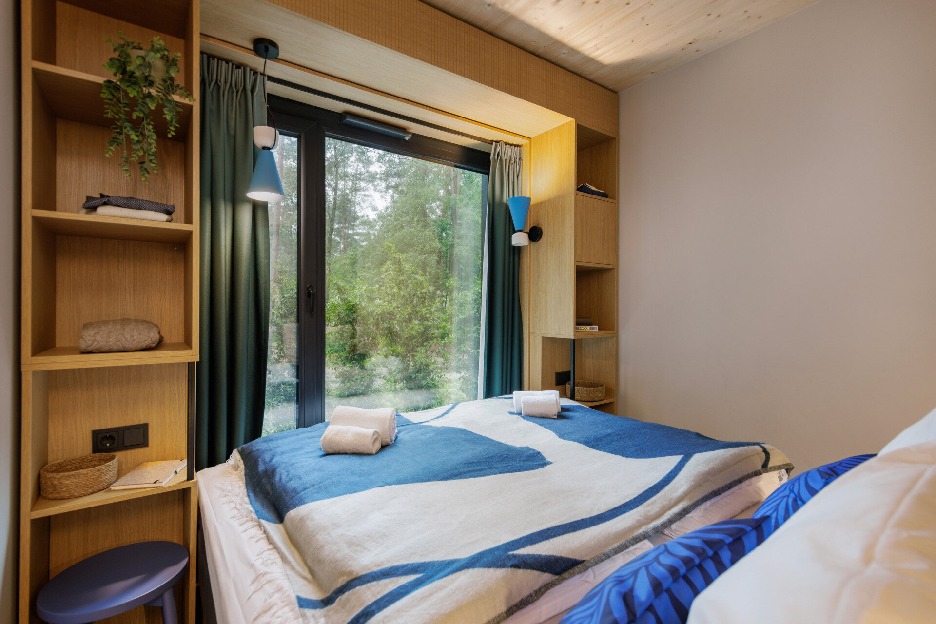 The bedrooms in this modern prefab cottage embrace natural light and wood finishes, creating a tranquil, grounded place to rest.