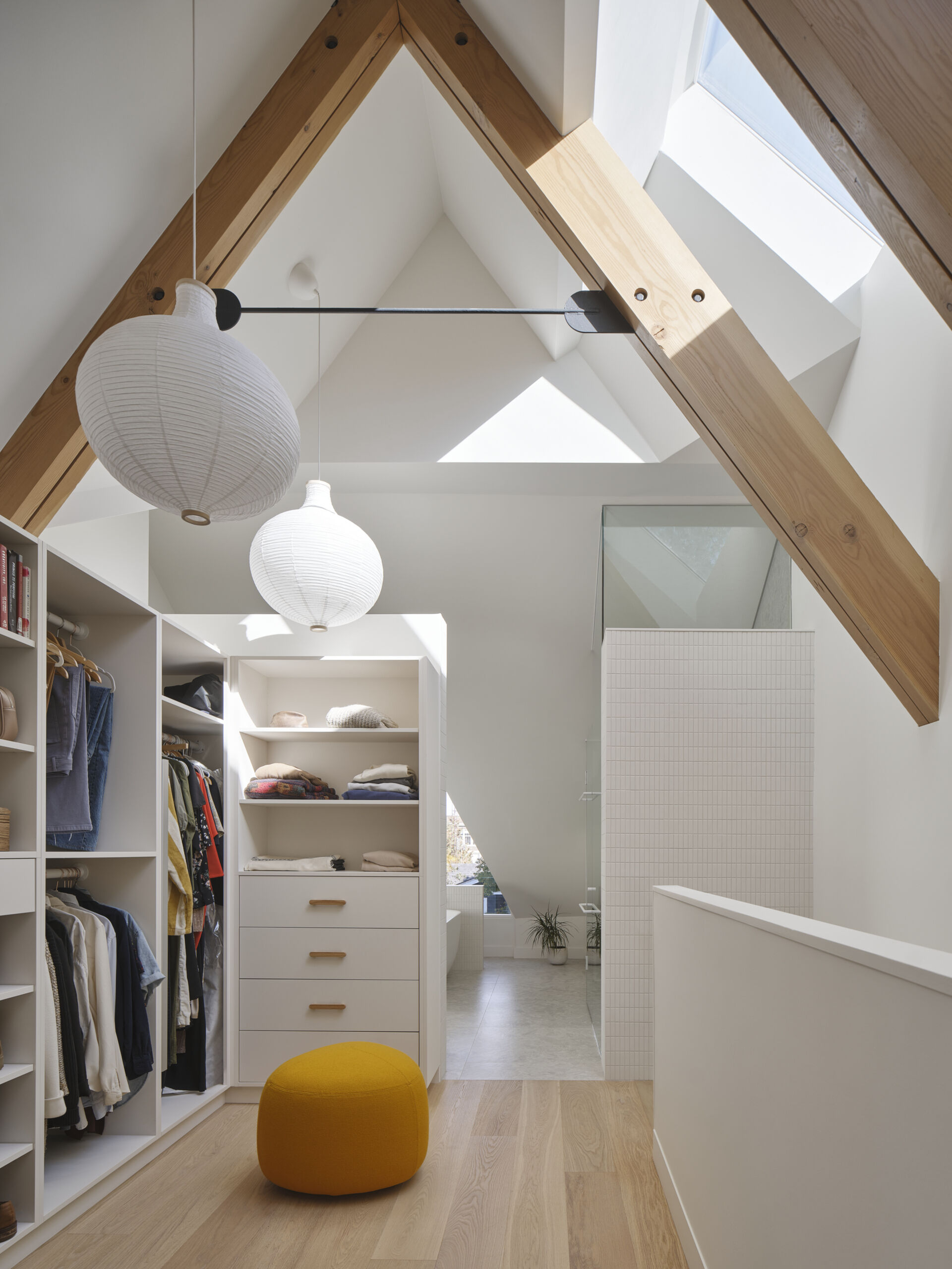 This walk-in closet uses full-height cabinetry and soft finishes to make daily routines simple and beautiful.