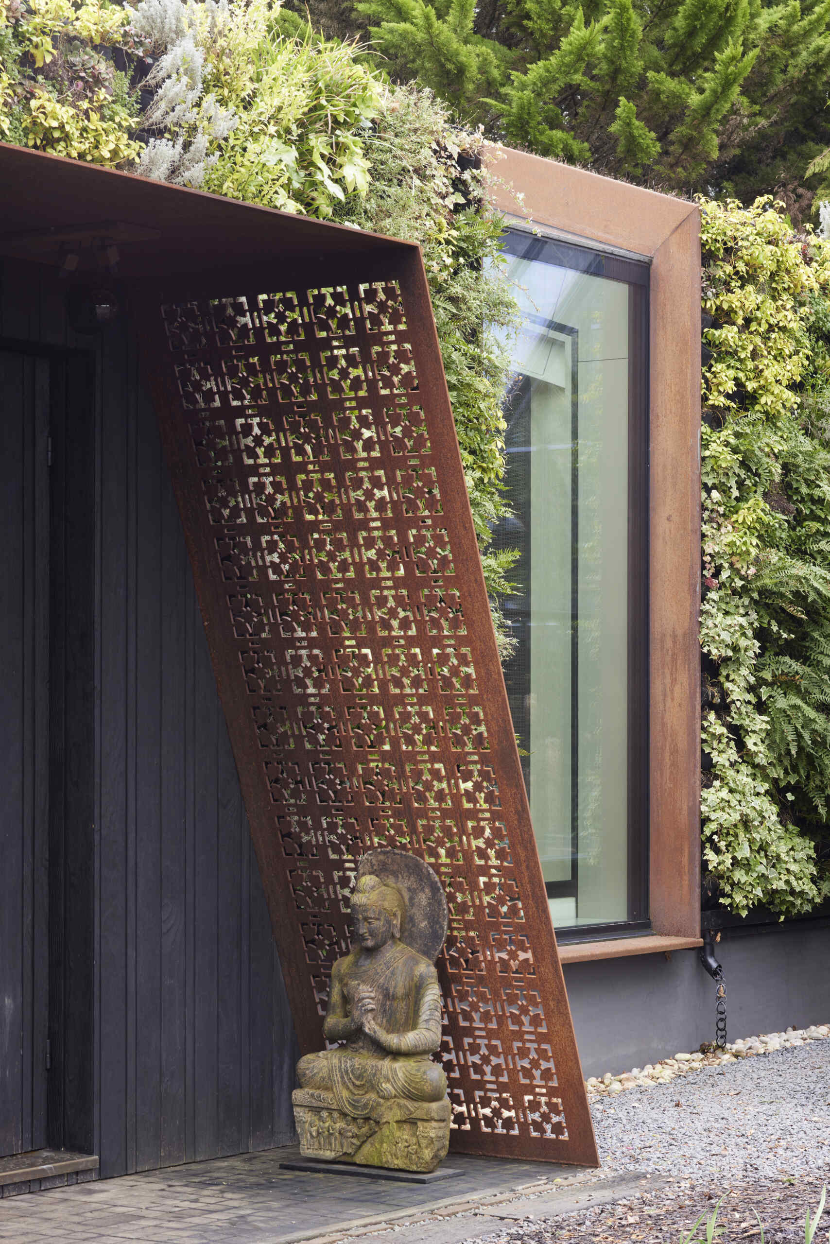 This modern music pavilion blends charred timber, Corten steel, and a living roof to create a sculptural retreat in the landscape.