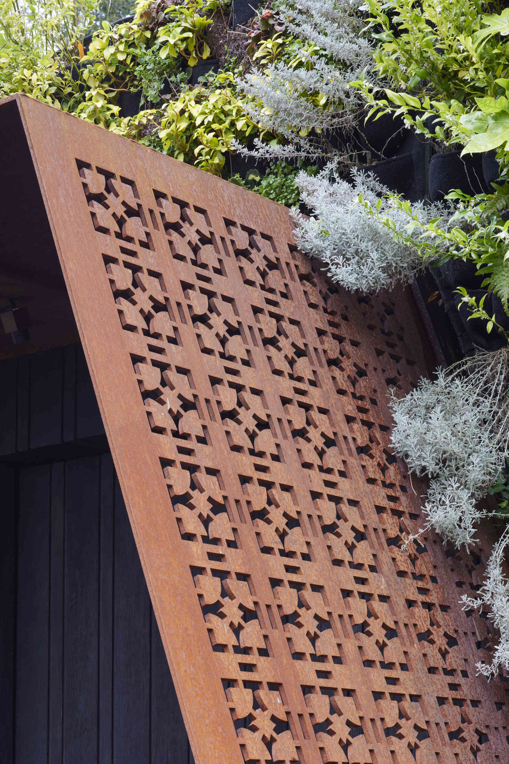 This modern music pavilion blends charred timber, Corten steel, and a living roof to create a sculptural retreat in the landscape.