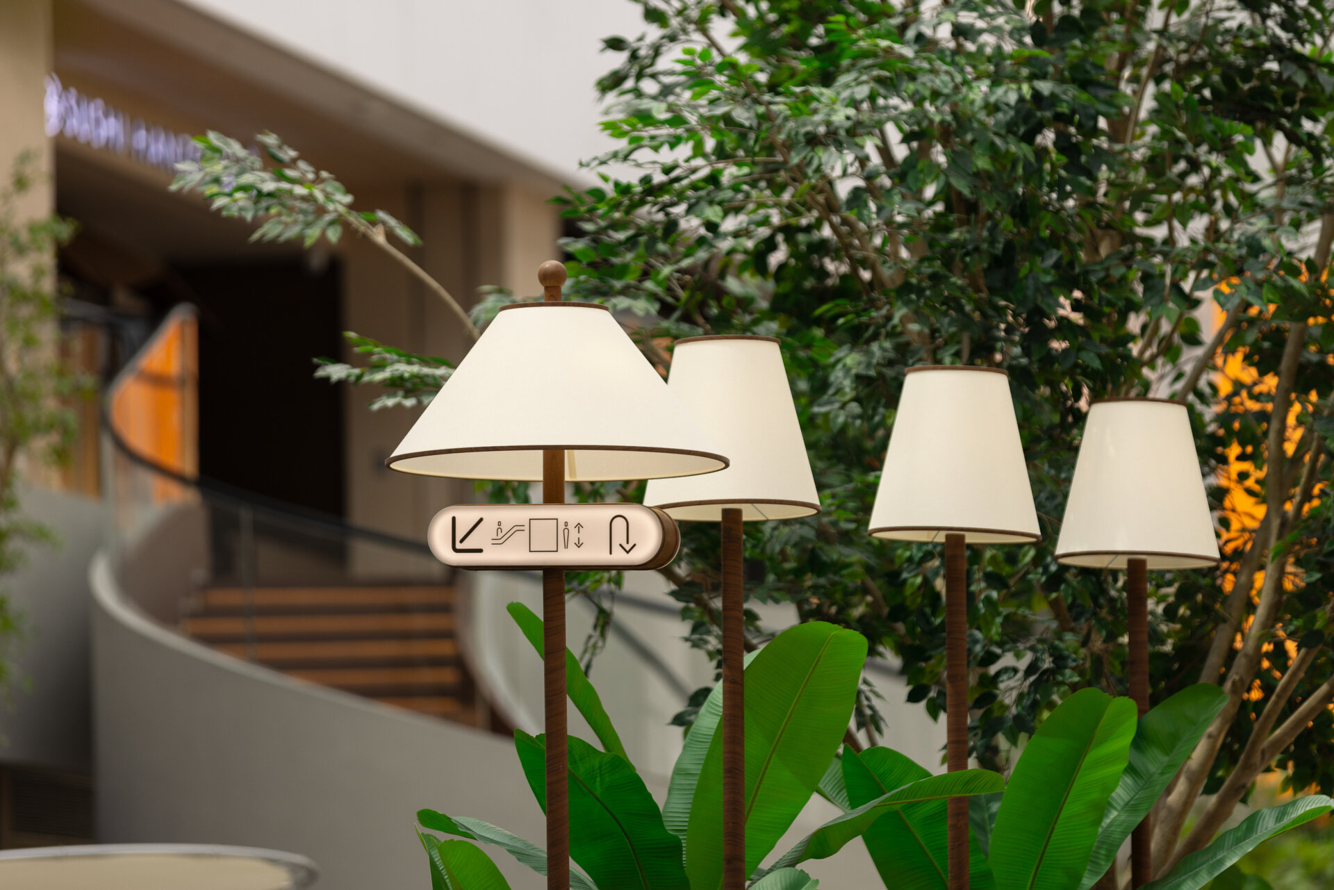 Floor lamps with wooden bases and soft fabric shades blend beautifully with the surrounding greenery. Thoughtful lighting that feels like part of the landscape, not apart from it.