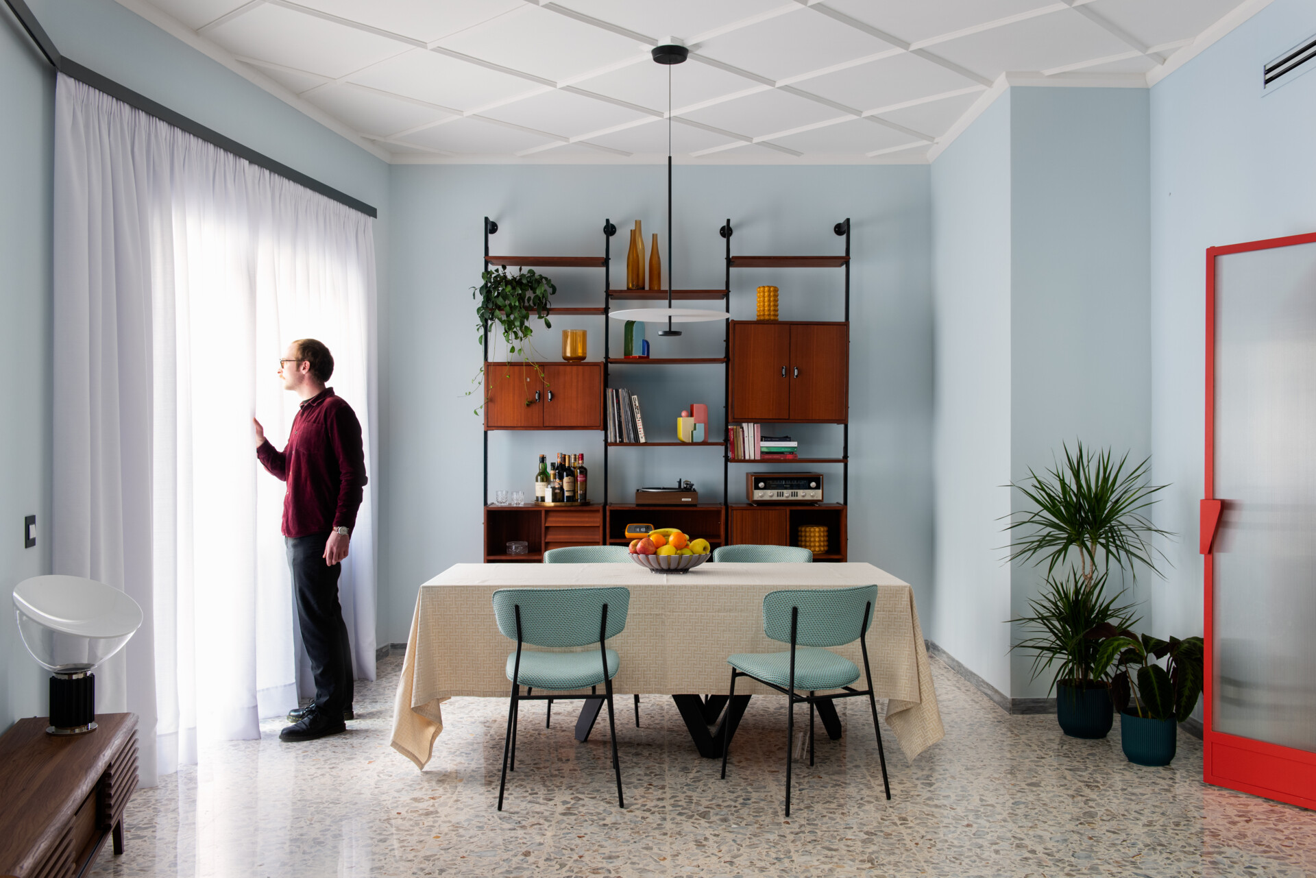 Vintage furniture warm up the dining area in this thoughtfully restored 1960s Roman apartment.