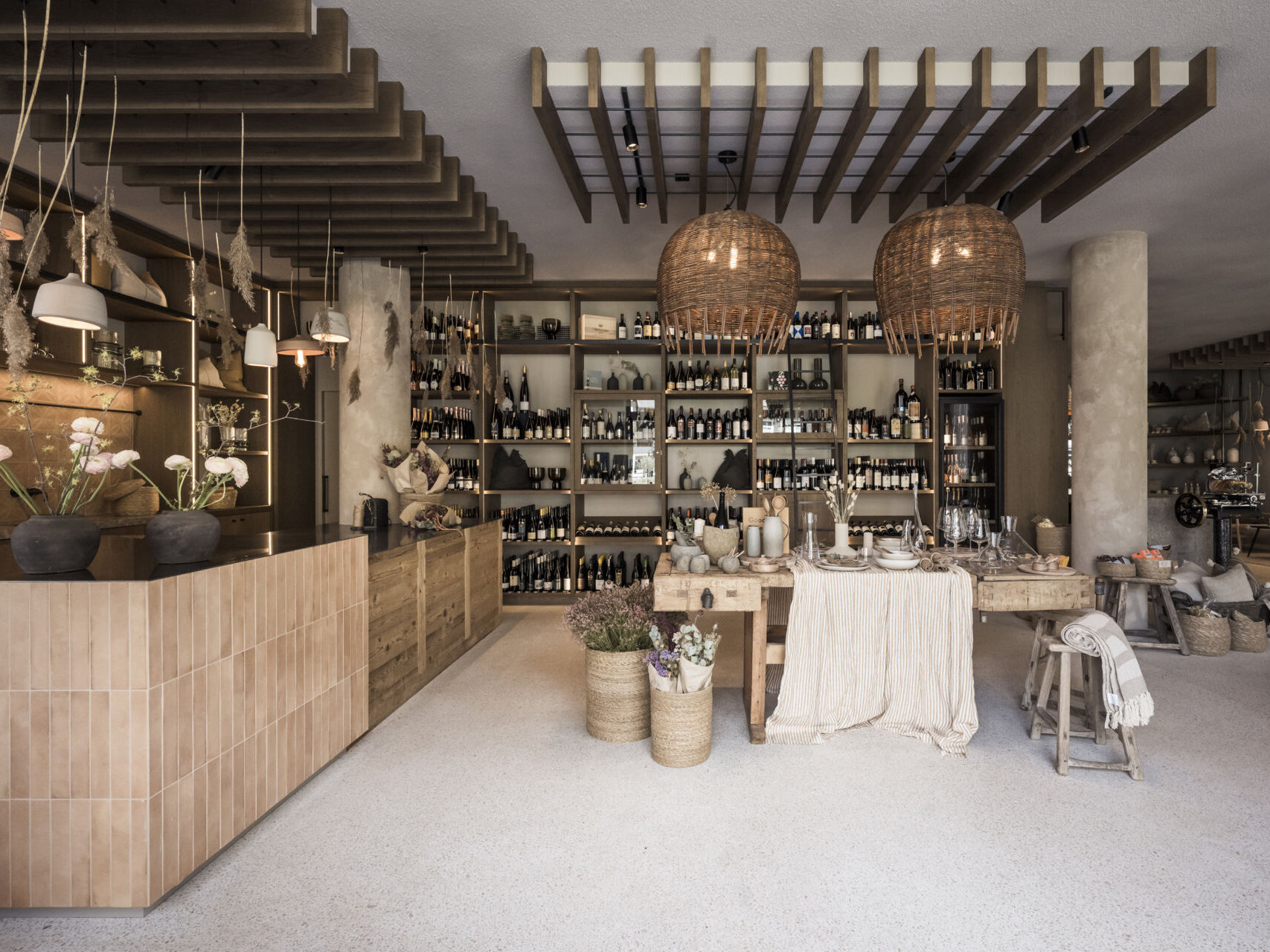A renovated barn transformed into a warm, curated retail space for regional craft, wine, and design, where hospitality meets storytelling in every detail.
