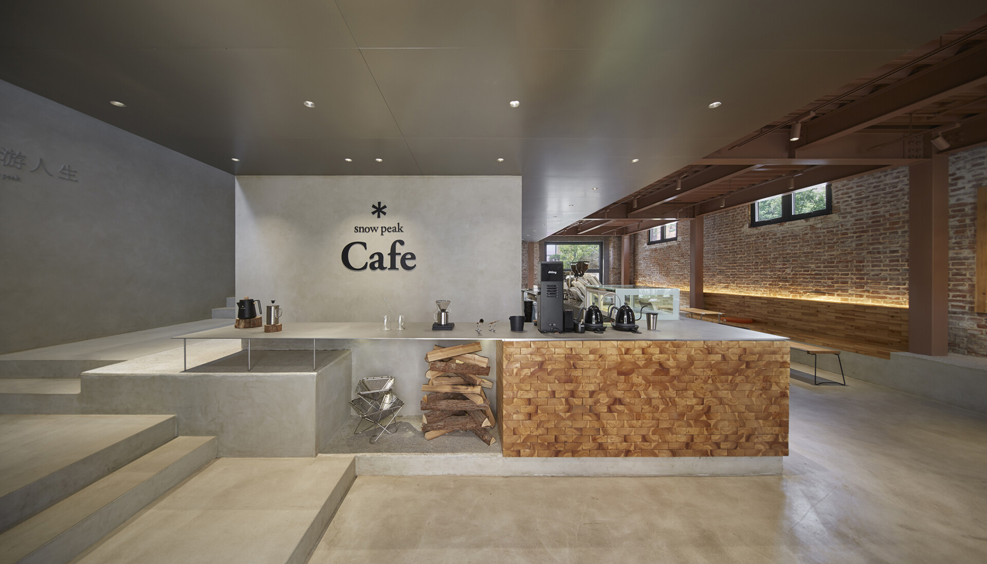 Stepping inside the renovated warehouse, and the central feature of the cafe is a large multi-functional bar that handles coffee service, retail display, and the checkout area.