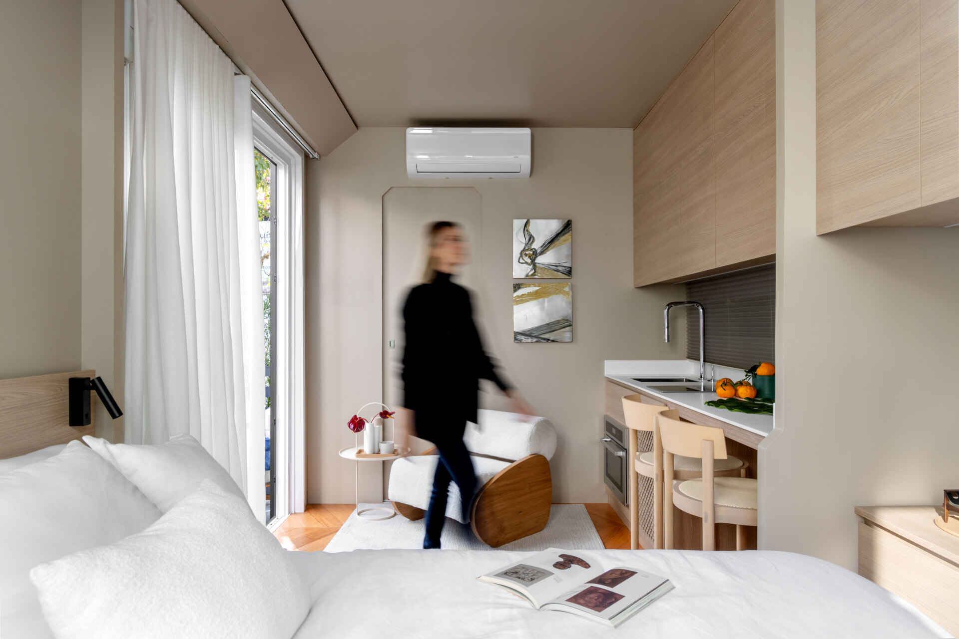 Inside this tiny house, every inch is intentional. Warm bamboo finishes, custom furniture, and smart tech create a calm, modern space that feels far bigger than its footprint. The open layout flows seamlessly between living, kitchen, and sleeping areas.