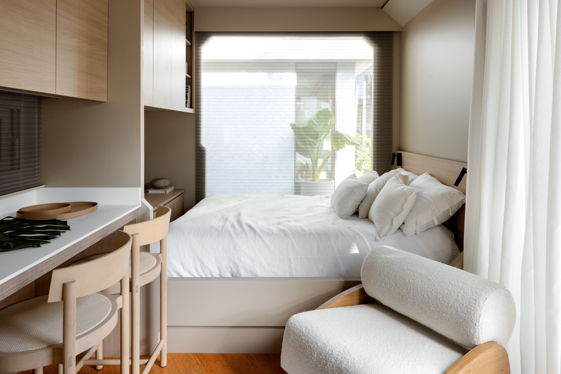 The sleeping nook in this modular home is simple yet cozy, tucked into an open-plan layout without feeling closed in. Soft textures, ambient lighting, and built-in elements create a restful corner that blends comfort and clarity.