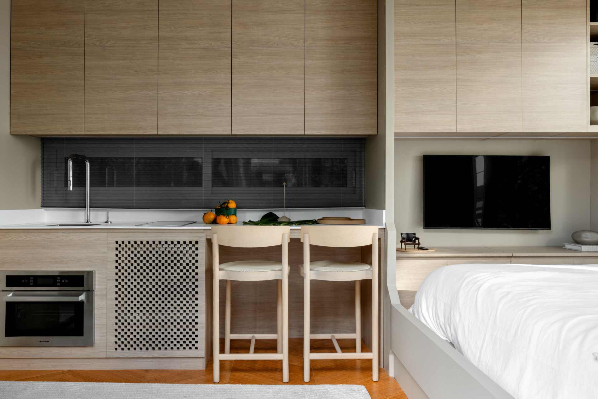 Inside this tiny house, every inch is intentional. Warm bamboo finishes, custom furniture, and smart tech create a calm, modern space that feels far bigger than its footprint. The open layout flows seamlessly between living, kitchen, and sleeping areas.