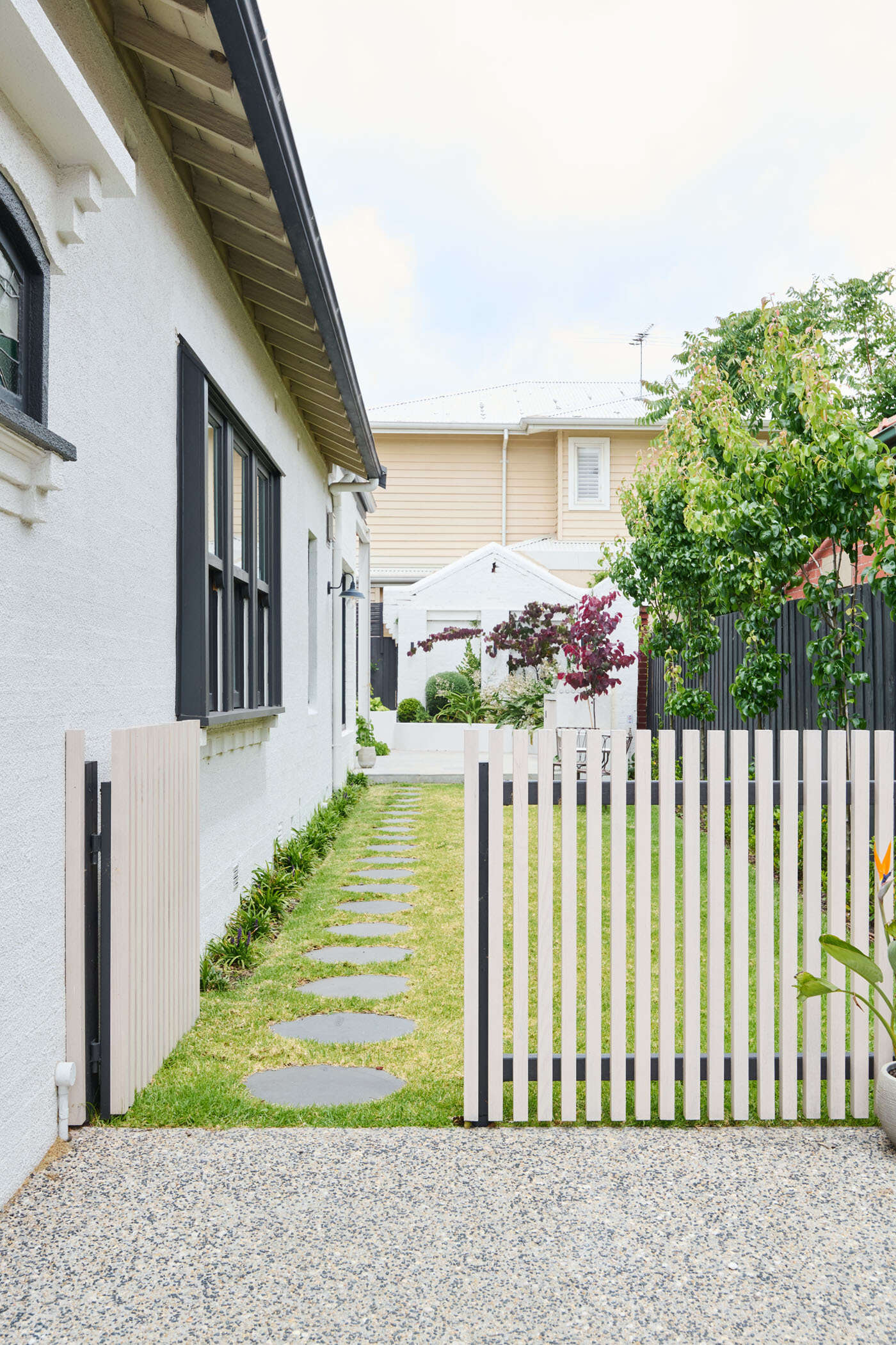 A serene family home in Elwood where heritage charm meets modern light-filled living. This sanctuary is all about natural textures, vaulted ceilings, and seamless garden connections.