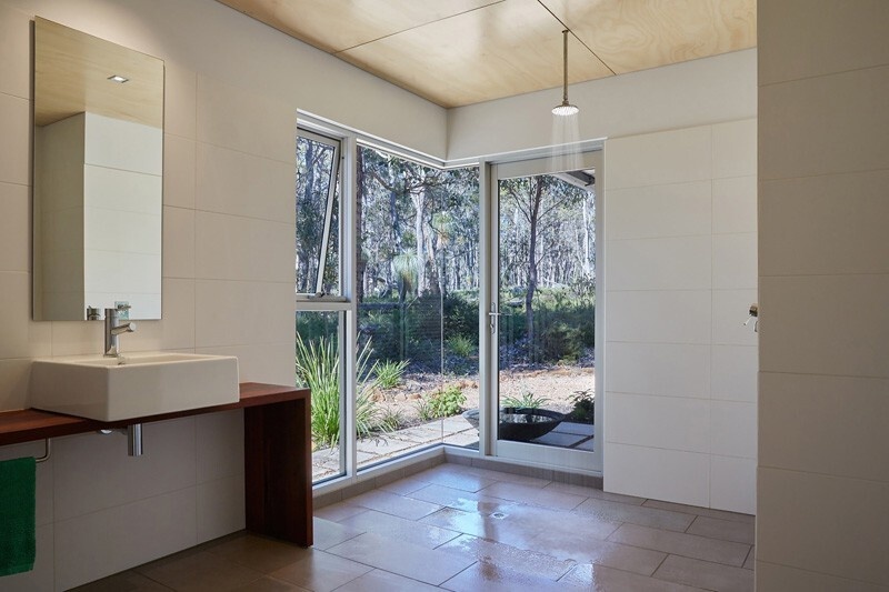 One of home's features is the use of corner windows that open the home to panoramic views of the bushland. These windows eliminate the typical sense of enclosure, creating the feeling of being surrounded by trees rather than separated from them.