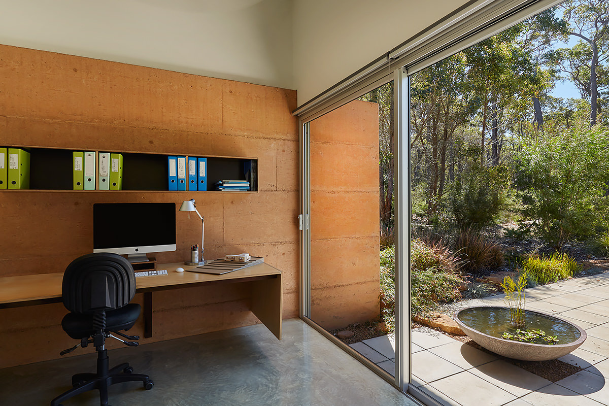 A light-filled home office with views to the bush, offering calm and focus within the open-plan layout.