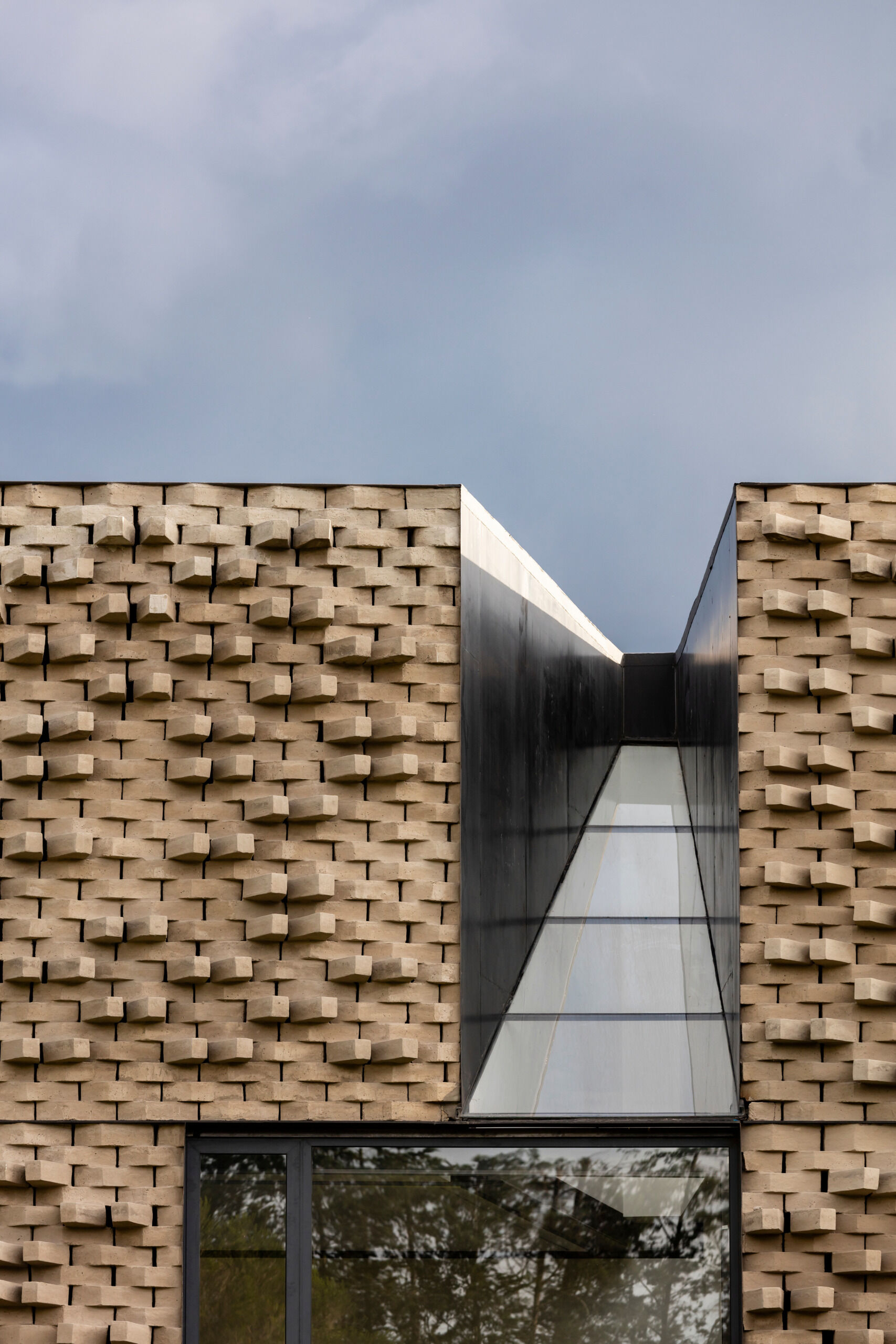 A modern home with a sculptural brick facade.