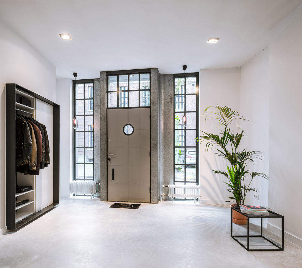 Step into a former workshop turned loft, where the entry opens directly into a light-filled interior that feels anything but industrial.