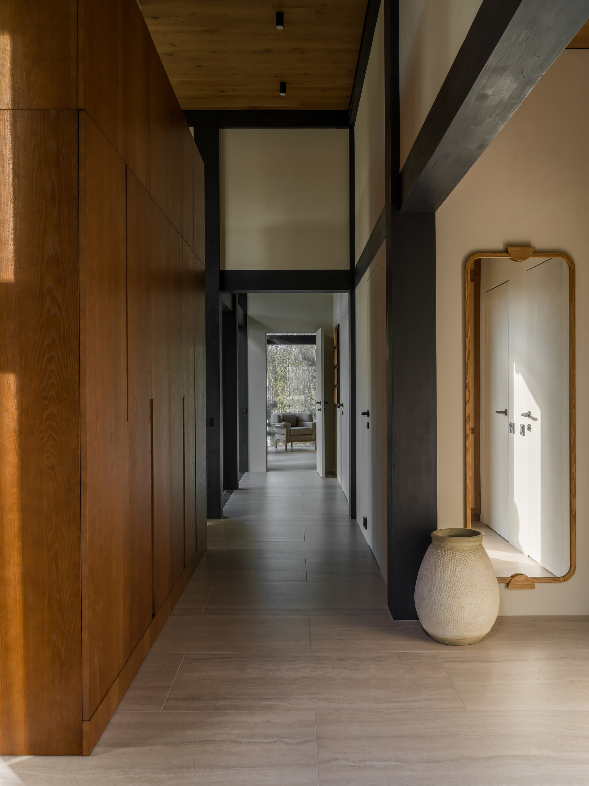This simple hallway connects spaces with no visual clutter, using warm materials to keep the tone consistent and the flow intuitive.