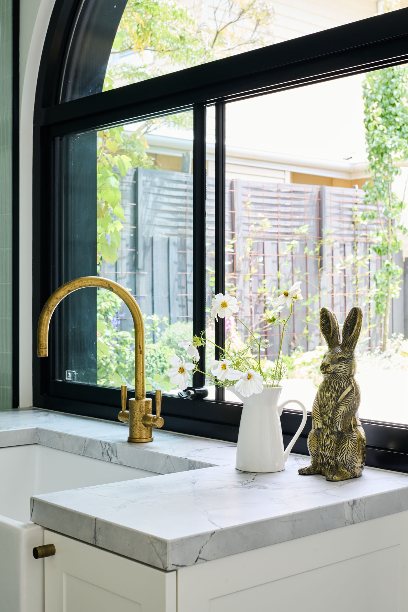 The checkerboard floor in this combined bathroom and laundry room adds a playful twist to the otherwise minimalist interiors. A perfect example of functional design with personality.