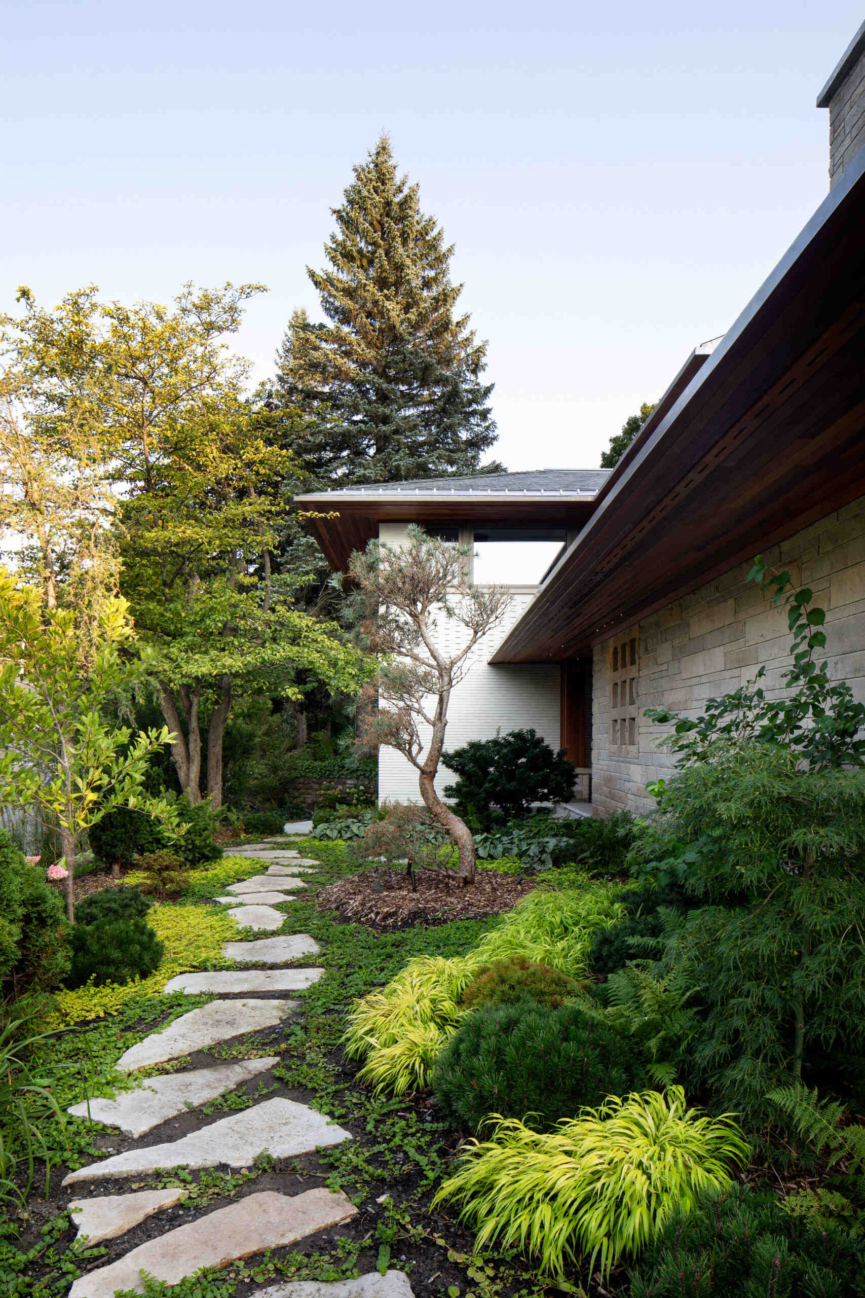 Nature plays a central role in the design of this home. A Japanese-influenced garden replaces traditional lawn with fragrant thyme and river pebbles. Carefully composed water features, including still ponds, a side courtyard fountain, and reflective basins, bring serenity and movement. The result is a meditative terrain that blurs the line between built and natural environments.