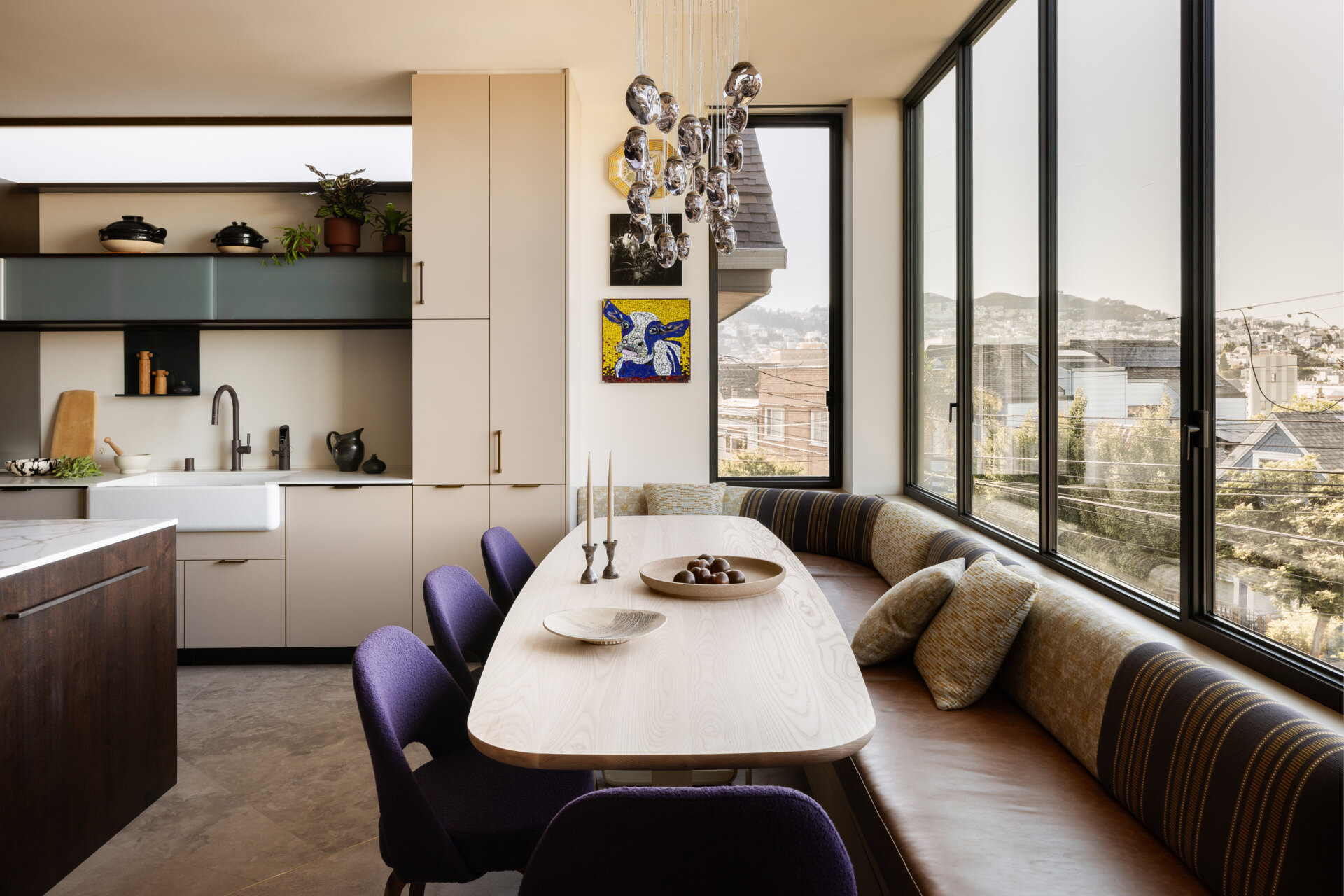 Anchored by pieces from the couple’s art collection, the dining area with banquette seating creates a quiet moment of pause between kitchen and lounge zones. The décor leans refined and personal, artful but not overly curated.