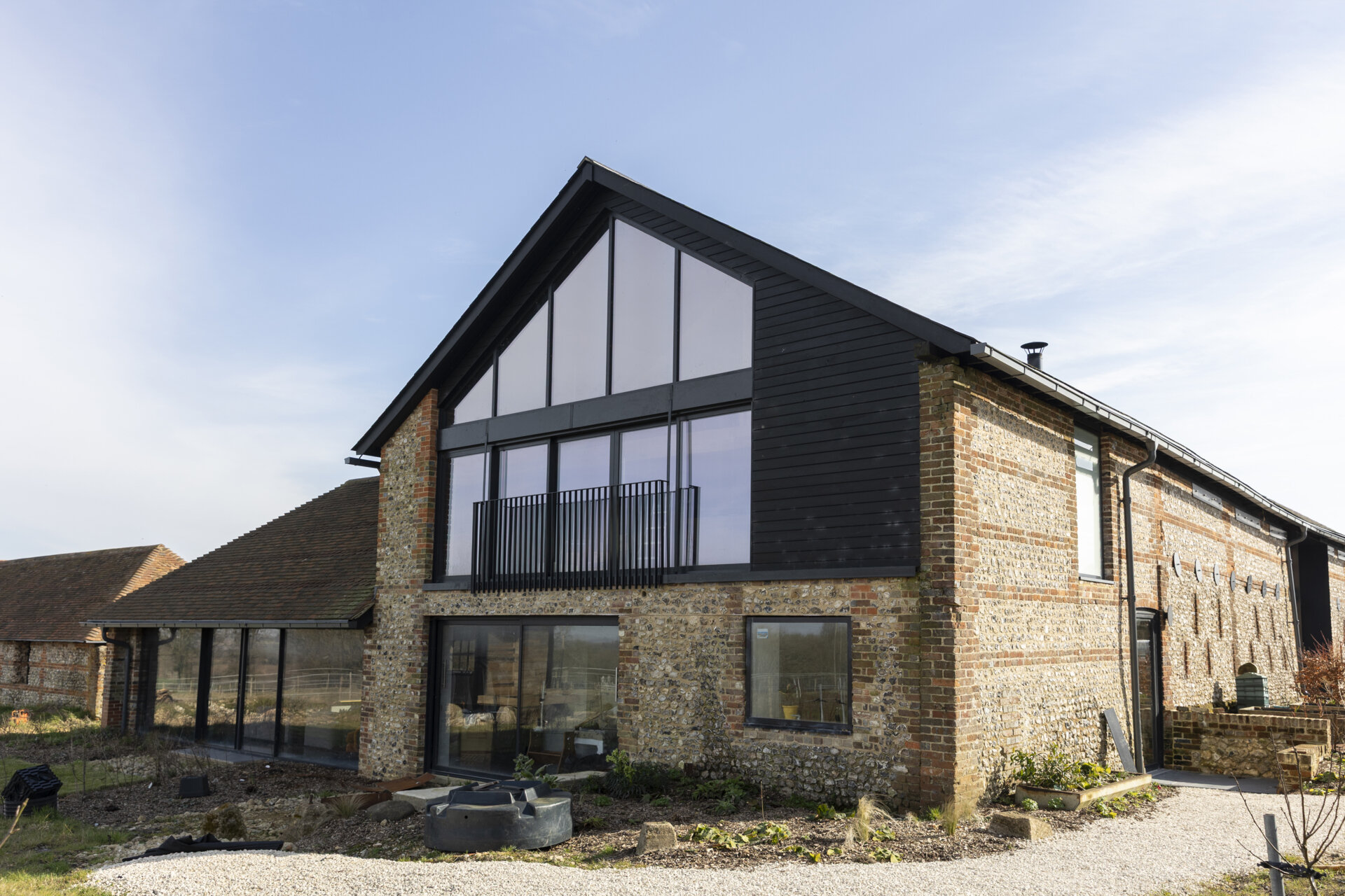 A collapsing dairy barn has been reimagined as a modern family home blending rustic charm with bold, contemporary design.