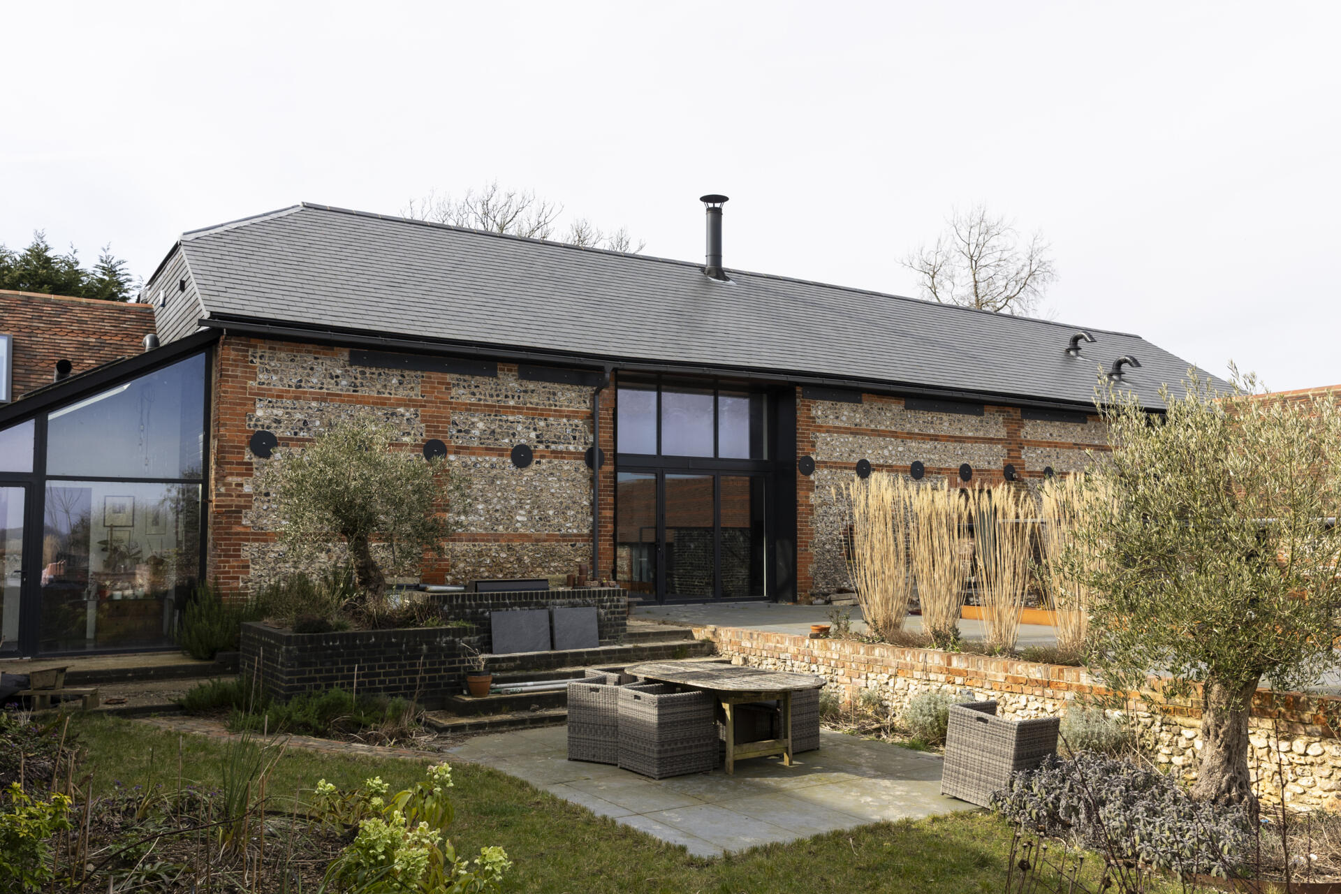 A collapsing dairy barn has been reimagined as a modern family home blending rustic charm with bold, contemporary design.