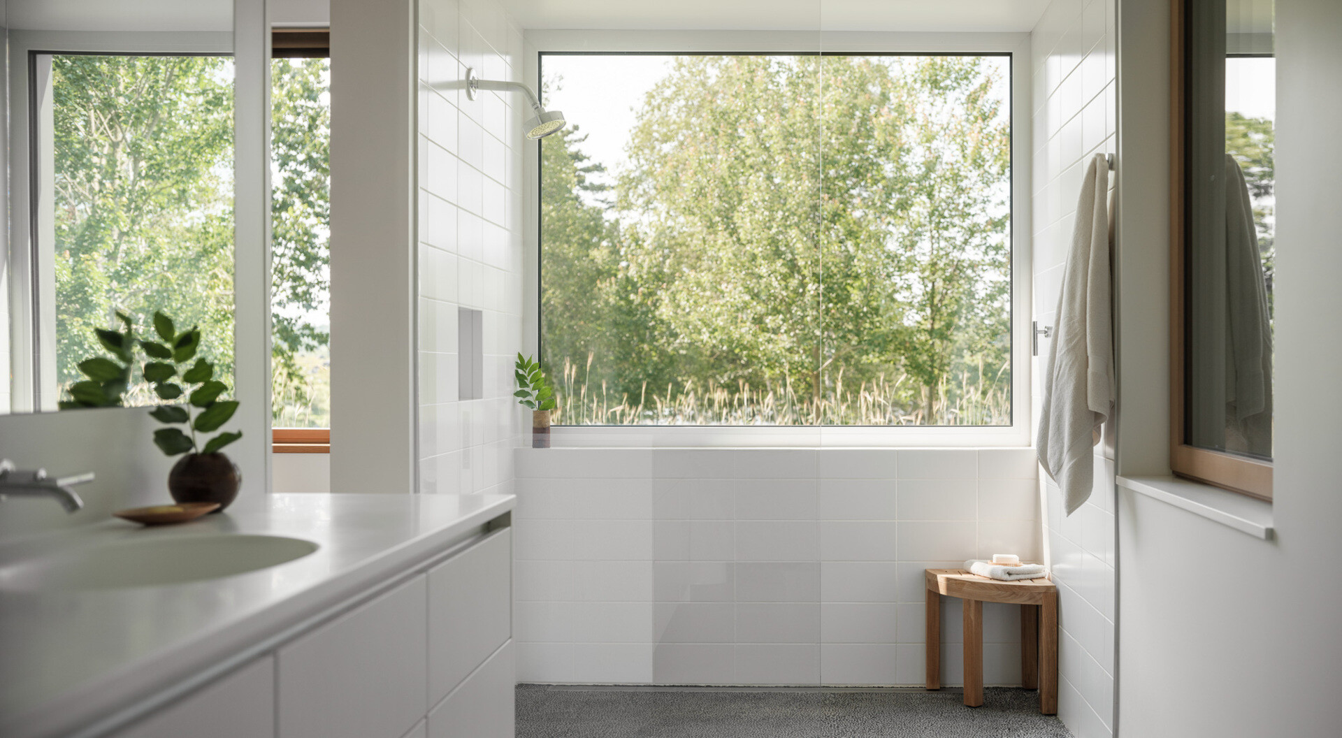 Bright and simple, the bathroom pairs energy efficiency with natural textures for a space that feels timeless and comfortable.
