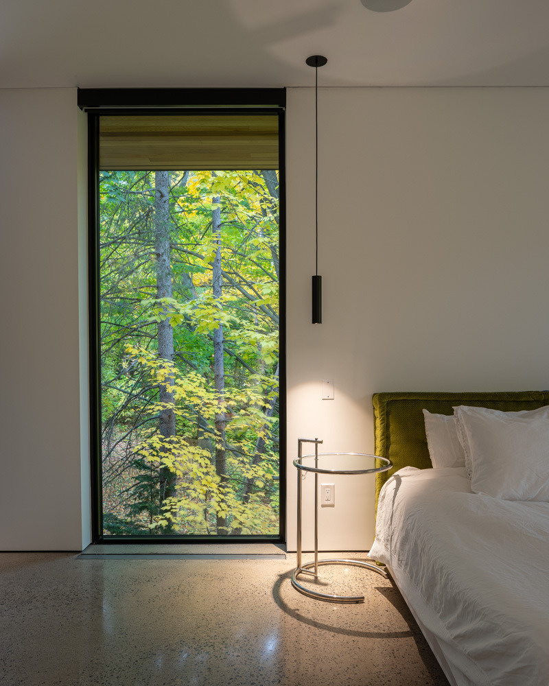 The primary suite features a private balcony and a serene, light-filled ensuite bathroom.