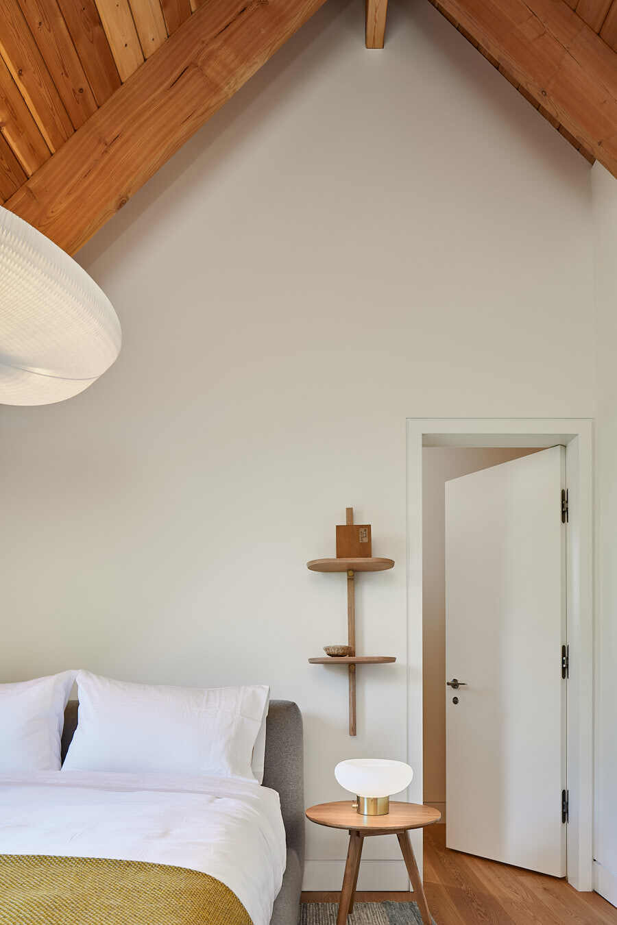Designed for comfort and privacy, the guest bedrooms extend along the home’s linear layout with understated beauty.