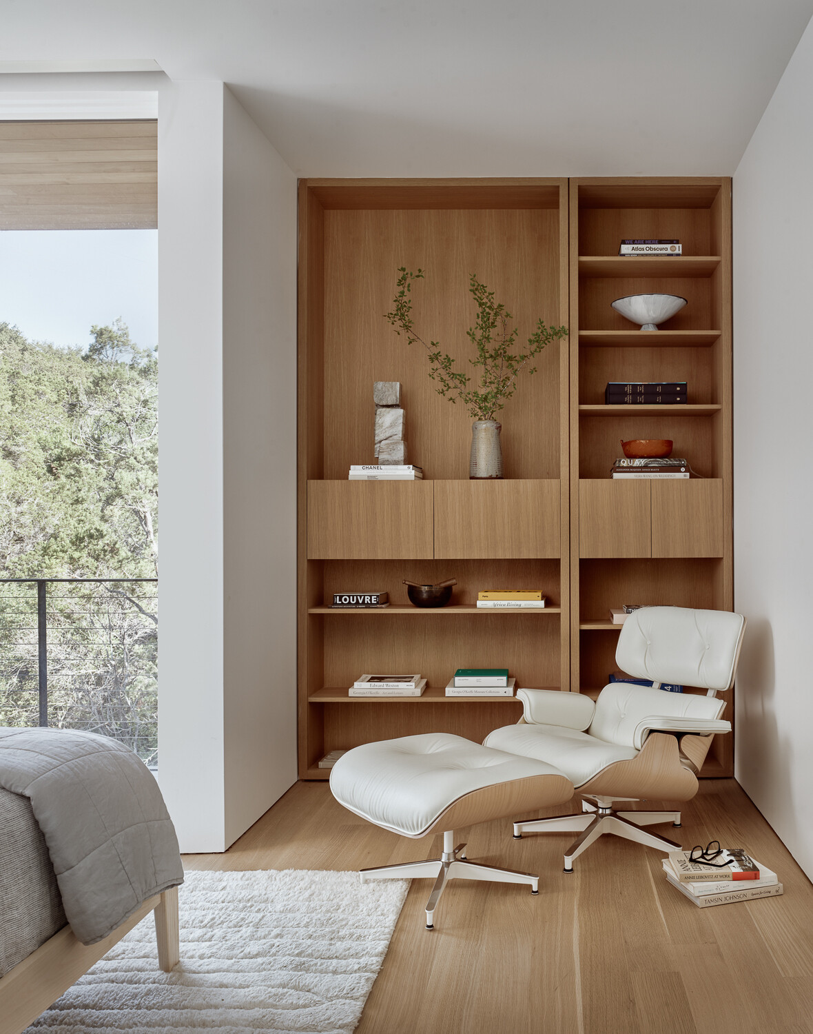 This bedroom features built-in shelving, offering both storage and a place to display personal touches. It’s a subtle but effective use of space that reflects the home’s efficiency-focused design.