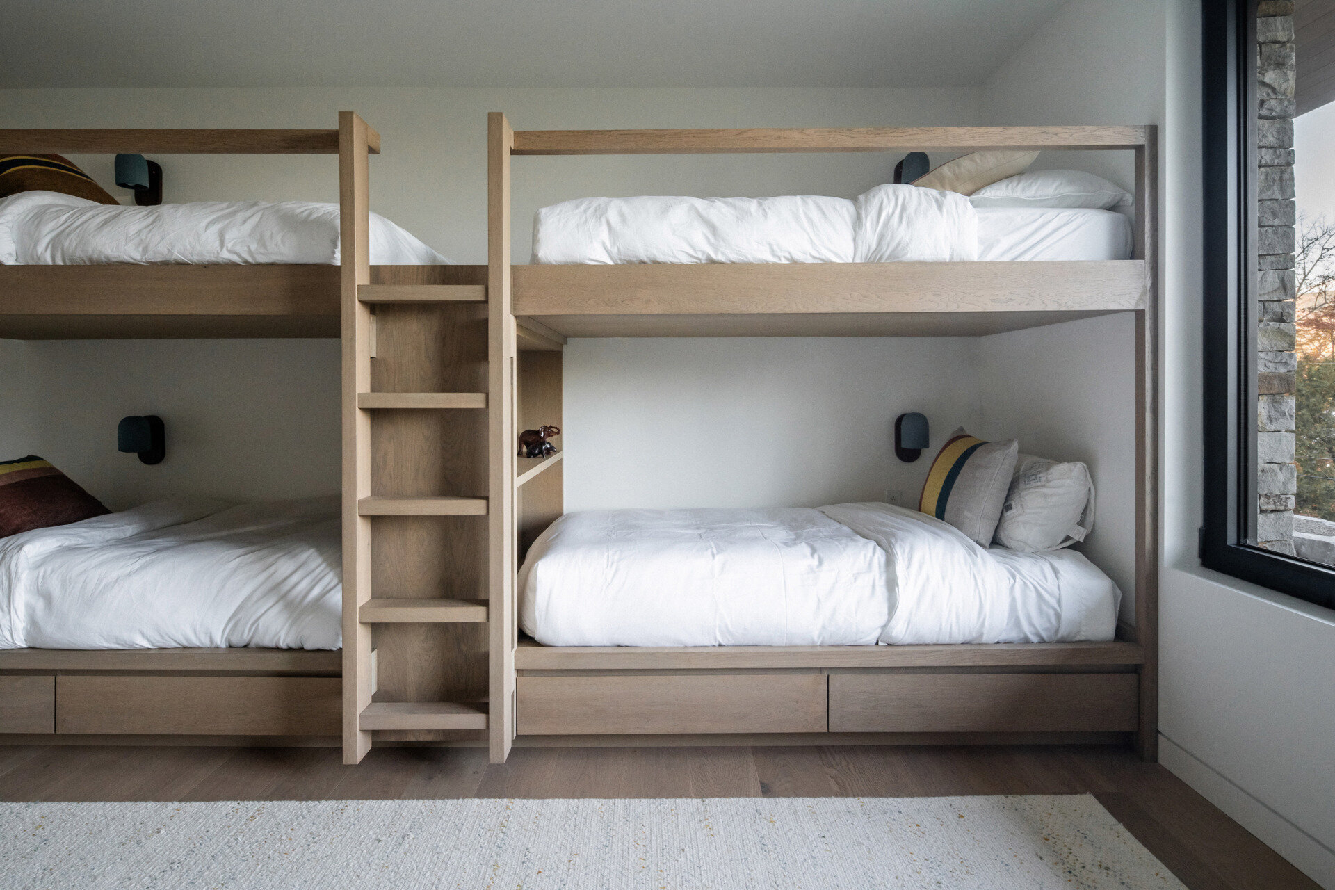 This modern bedroom is designed specifically for children, complete with custom bunk beds and proximity to the shared family lounge.