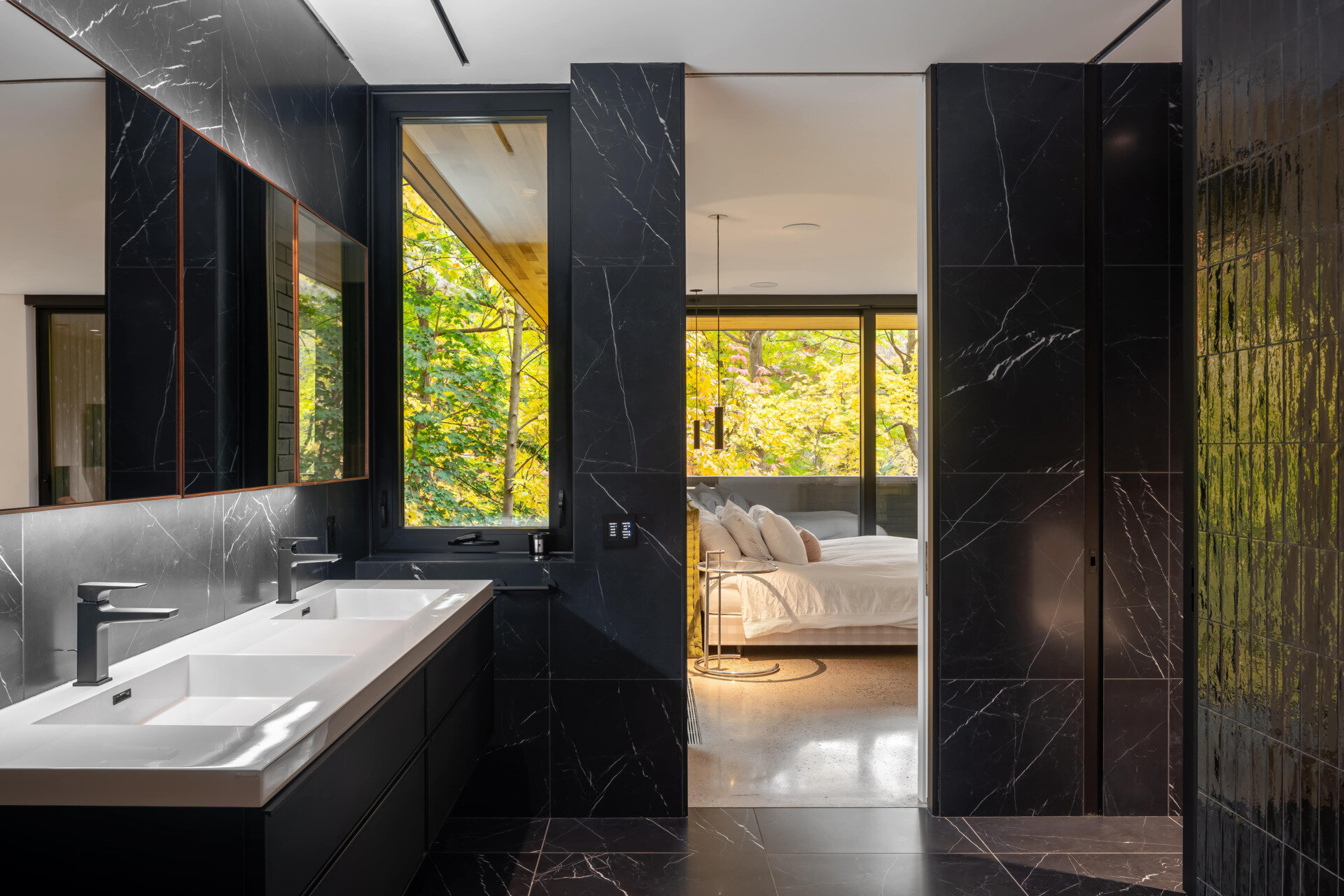 The primary suite features a private balcony and a serene, light-filled ensuite bathroom.