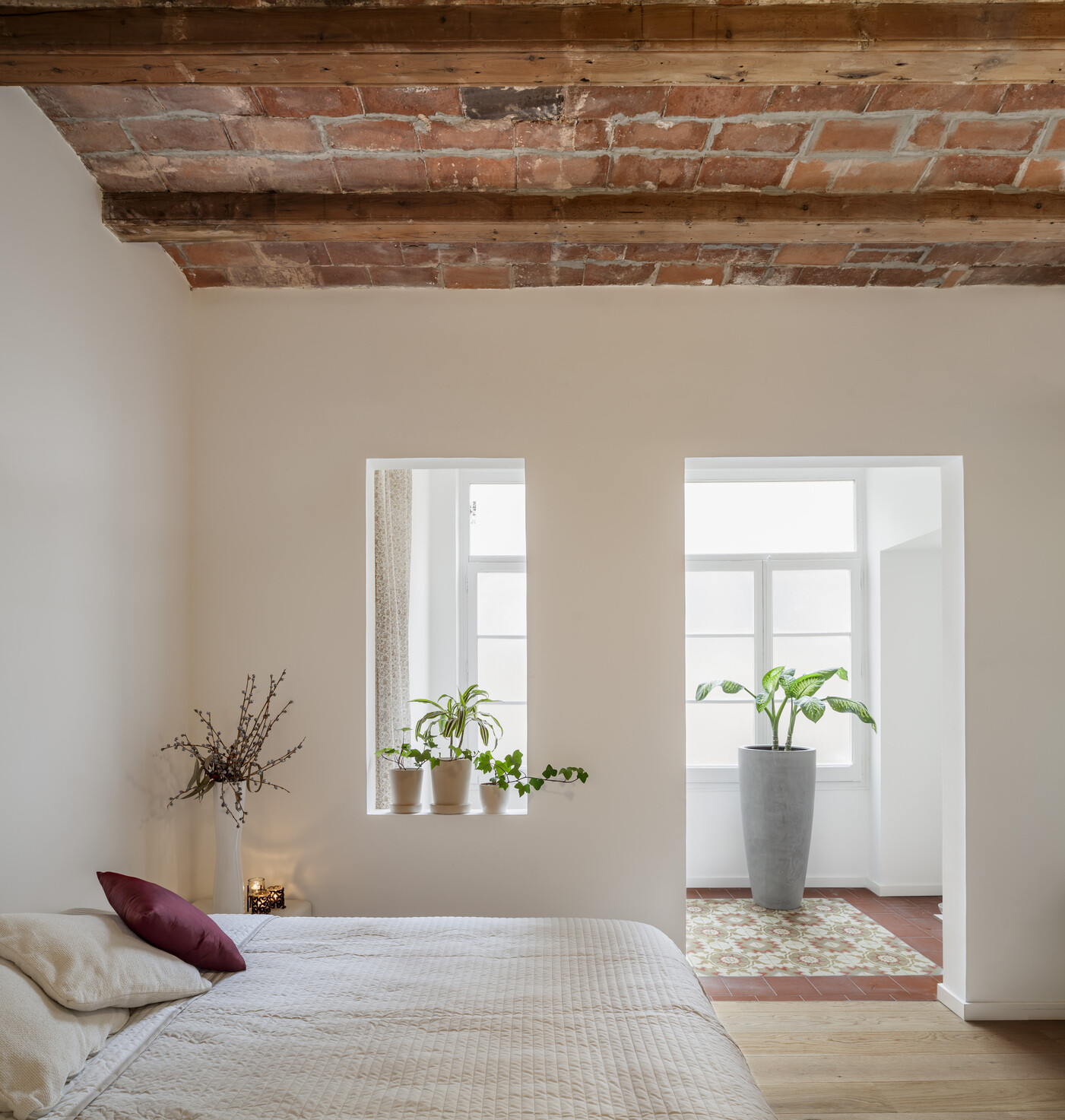 Elevated on a quiet platform, the bedroom offers a restful retreat defined by warm wood, soft light, and subtle transitions.